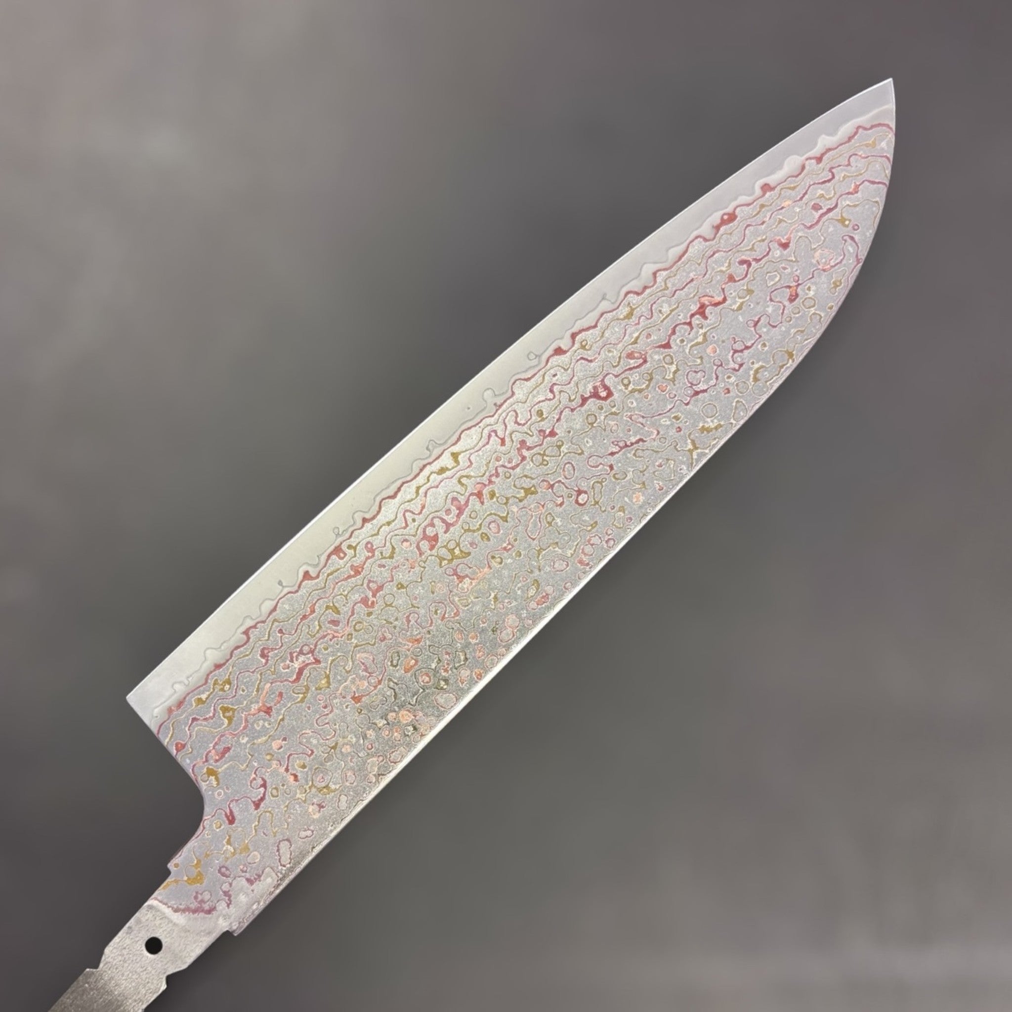 Kujaku rainbow damascus pattern close-up on santoku blade