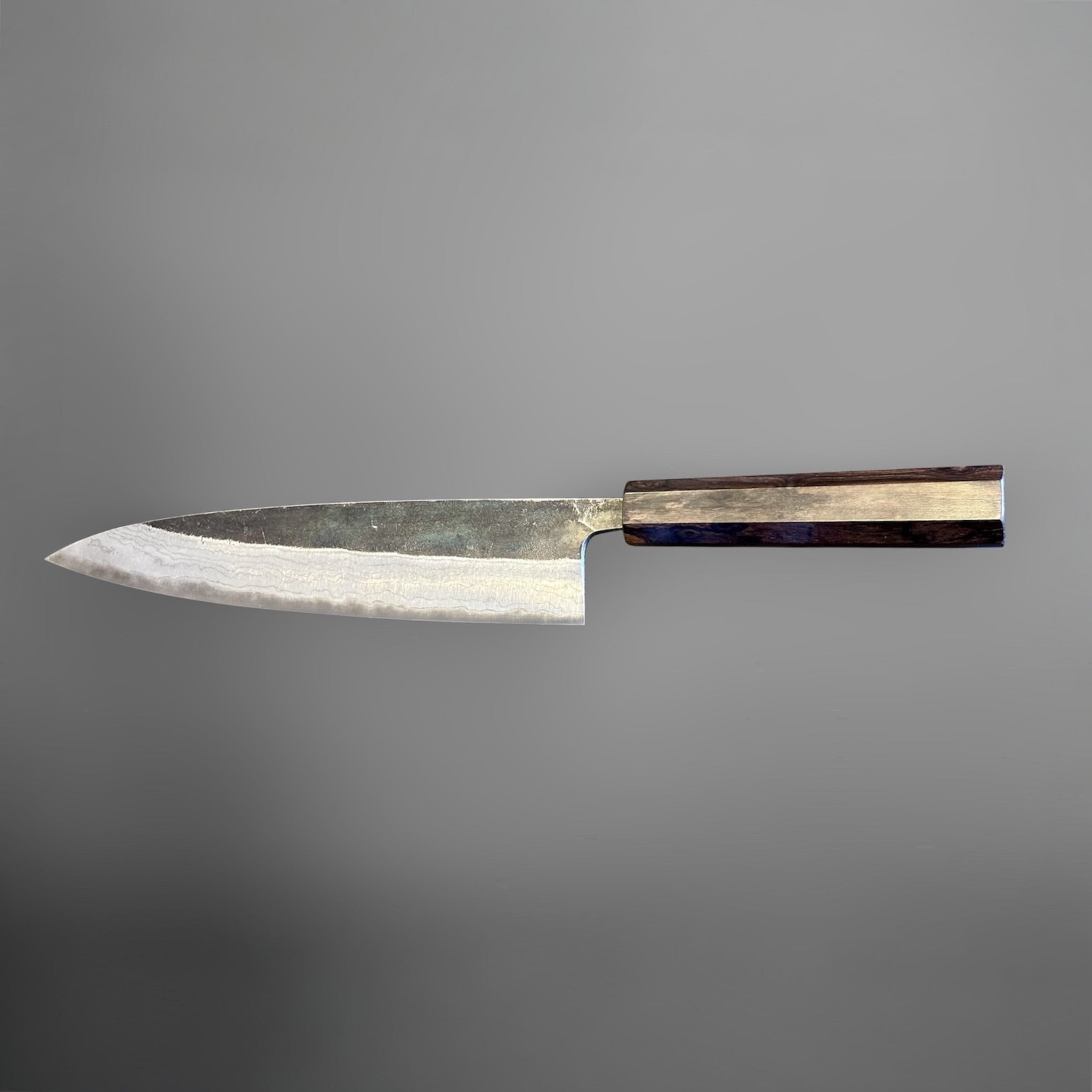 Hatsukokoro Kumokage Blue #2 Gyuto 240 mm with mono ebony handle, side profile showing the blade geometry and wa handle.