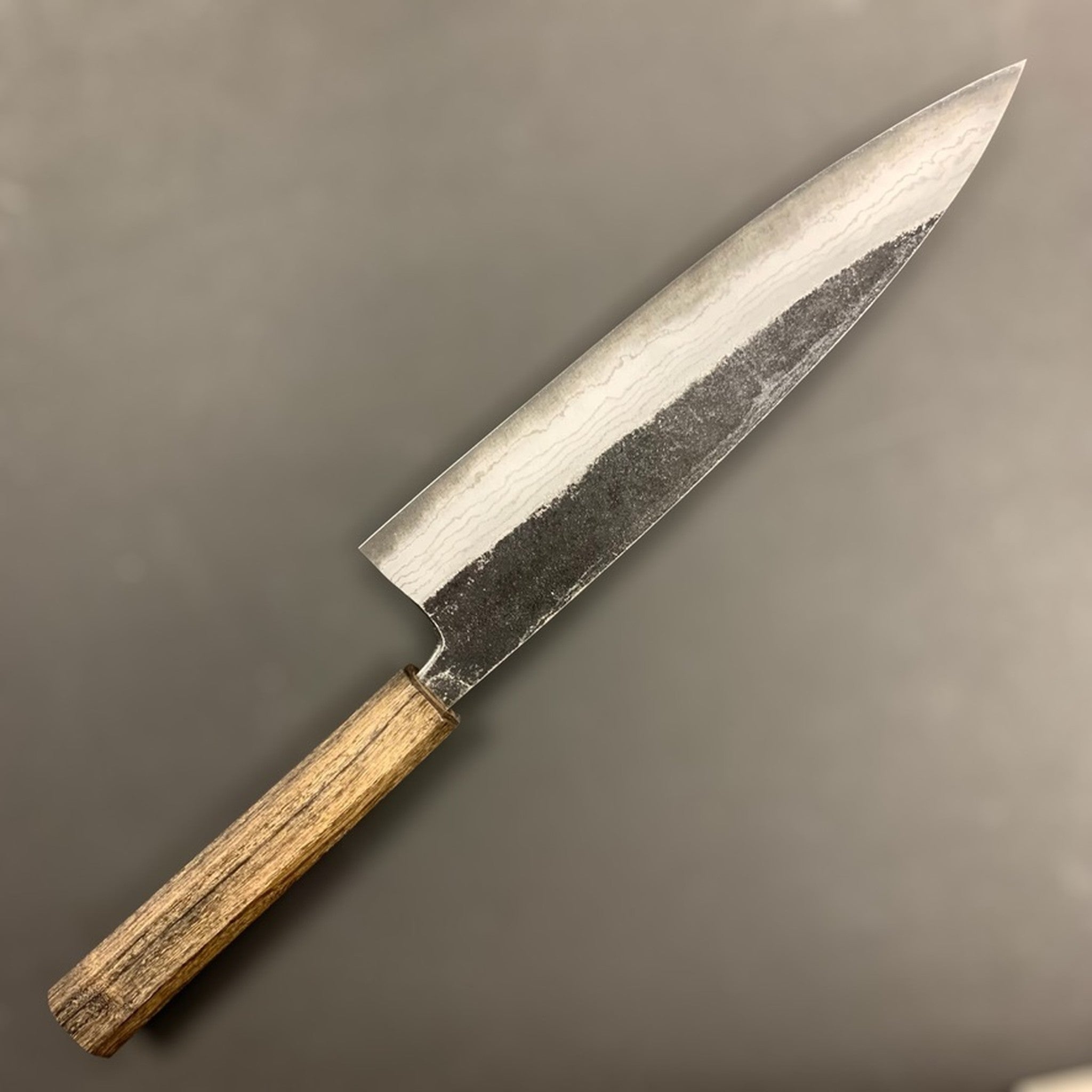Hatsukokoro Kumokage Blue #2 Kurouchi Damascus Gyuto 210 mm, showing layered Damascus finish and rustic kurouchi cladding.