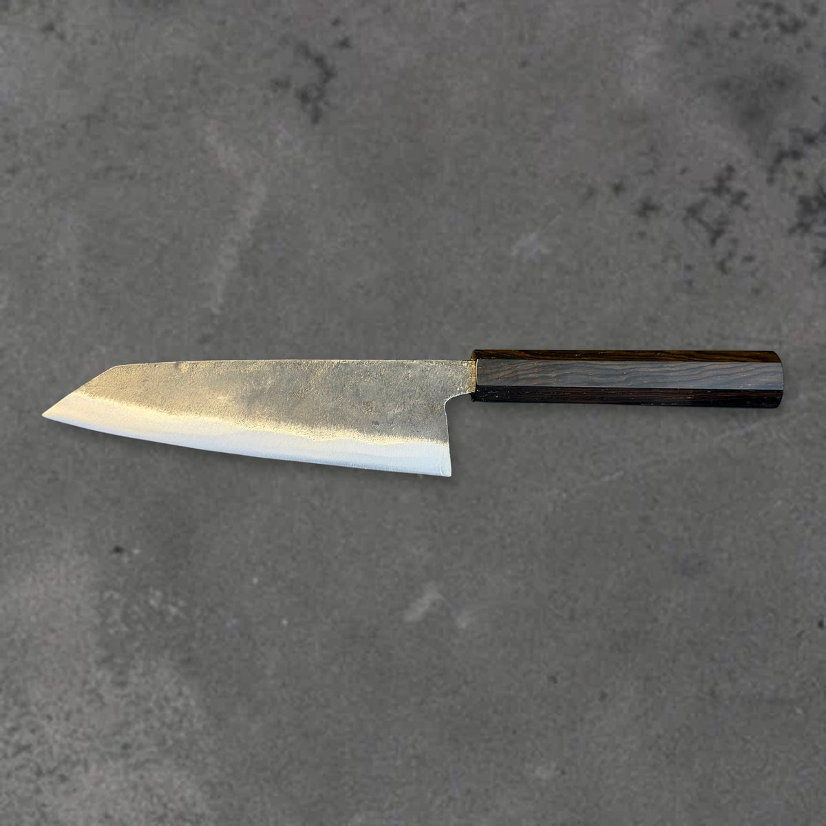 Hatsukokoro Kurogane Blue #2 Kurouchi 140mm bunka with ebony handle, shown in horizontal reverse profile with the full blade and handle visible.
