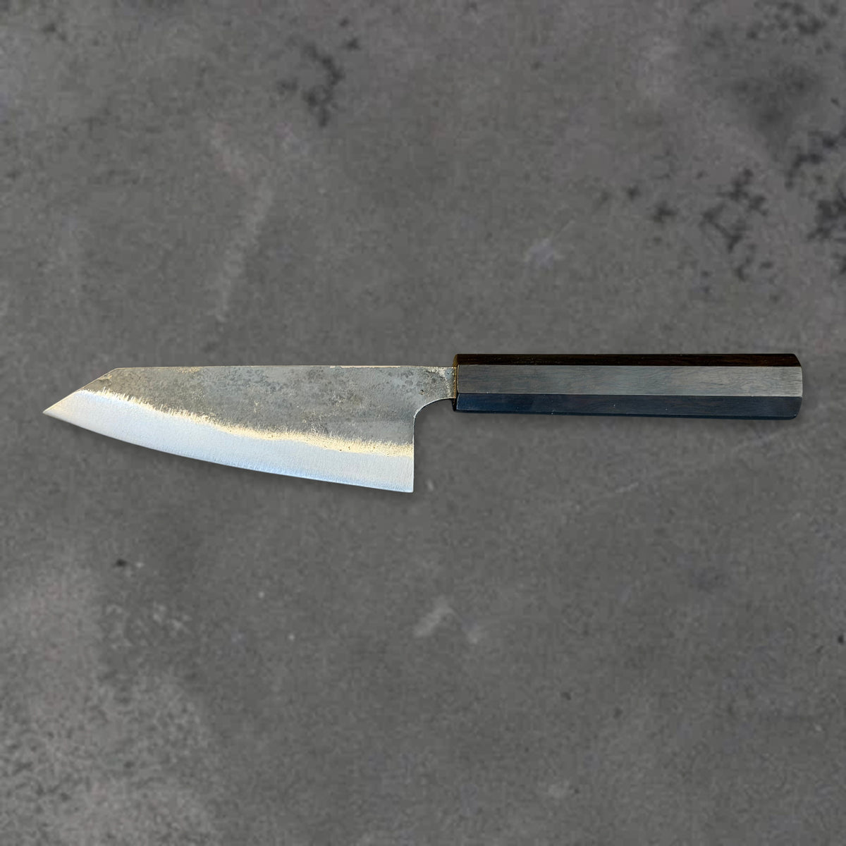 Hatsukokoro Kurogane Blue #2 Kurouchi 120mm ko-bunka with ebony handle, shown in horizontal reverse profile with the full blade and handle visible.
