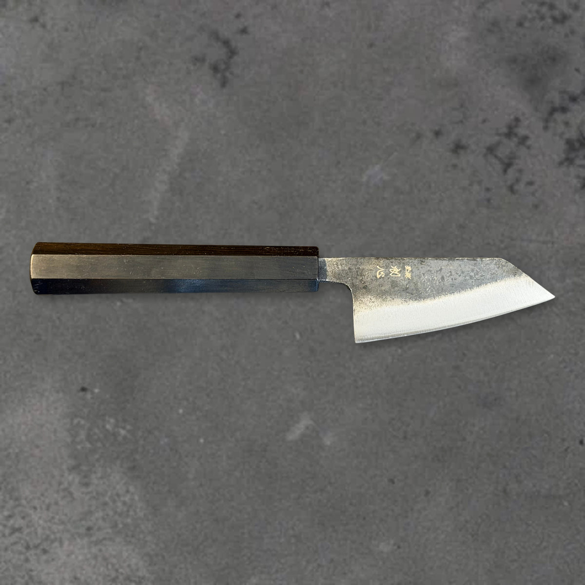 Hatsukokoro Kurogane Blue #2 Kurouchi 80mm ko-bunka with ebony handle, shown in horizontal front profile with the full blade and handle visible.