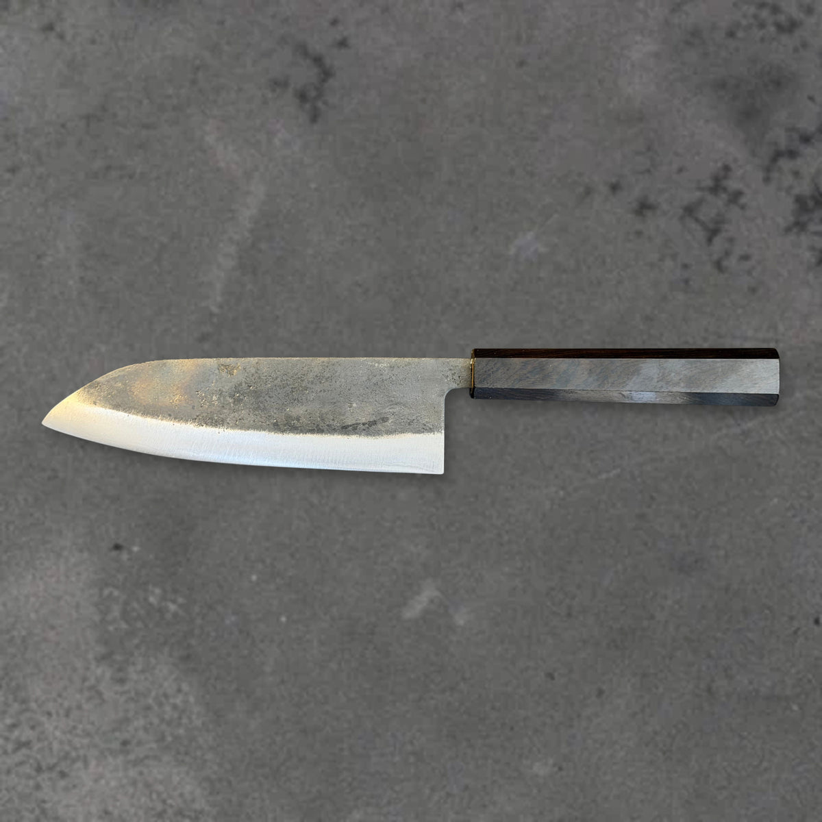 Hatsukokoro Kurogane Blue #2 Kurouchi 165mm santoku with ebony handle, shown in horizontal reverse profile with the full blade and handle visible.