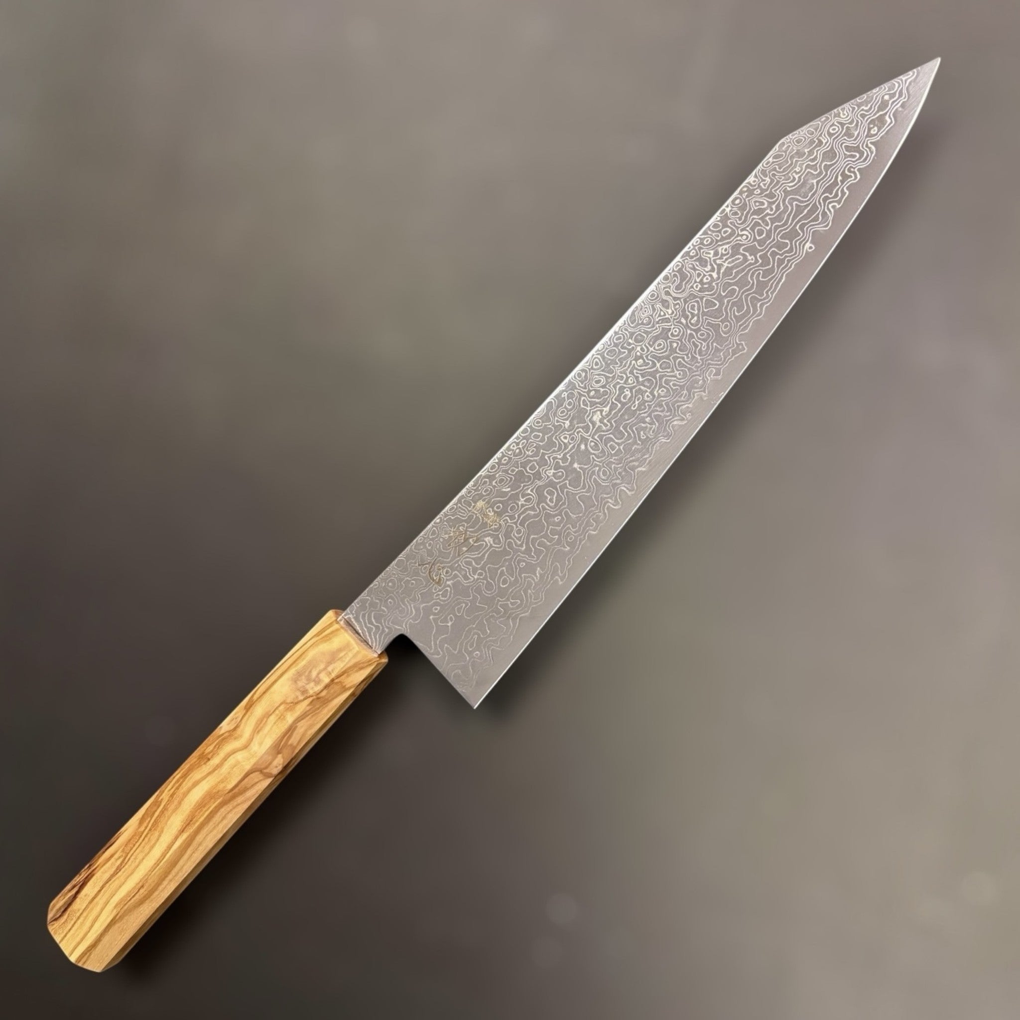 Hatsukokoro Ryuhyo SG2 Damascus Kiritsuke 240 mm, right side showcasing the intricate Damascus pattern and unique kiritsuke tip with an olive wood handle.