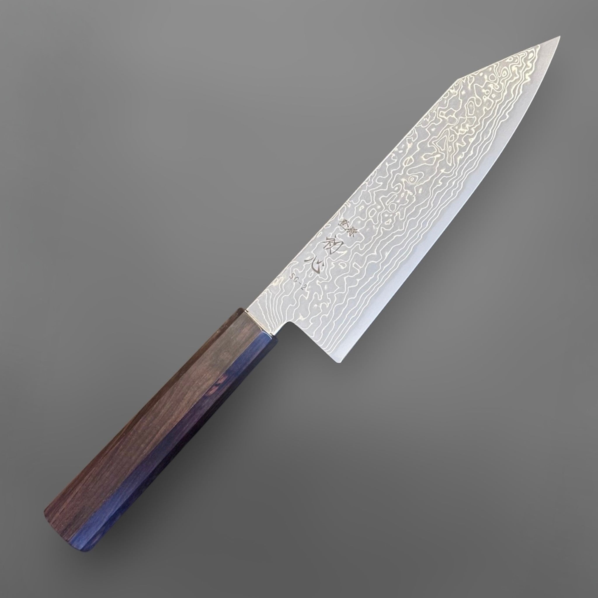 Hatsukokoro Ryuhyo SG2 Damascus Migaki Bunka with Mono Ebony Handle, angled front view showing the Damascus pattern and octagonal mono ebony wa handle.