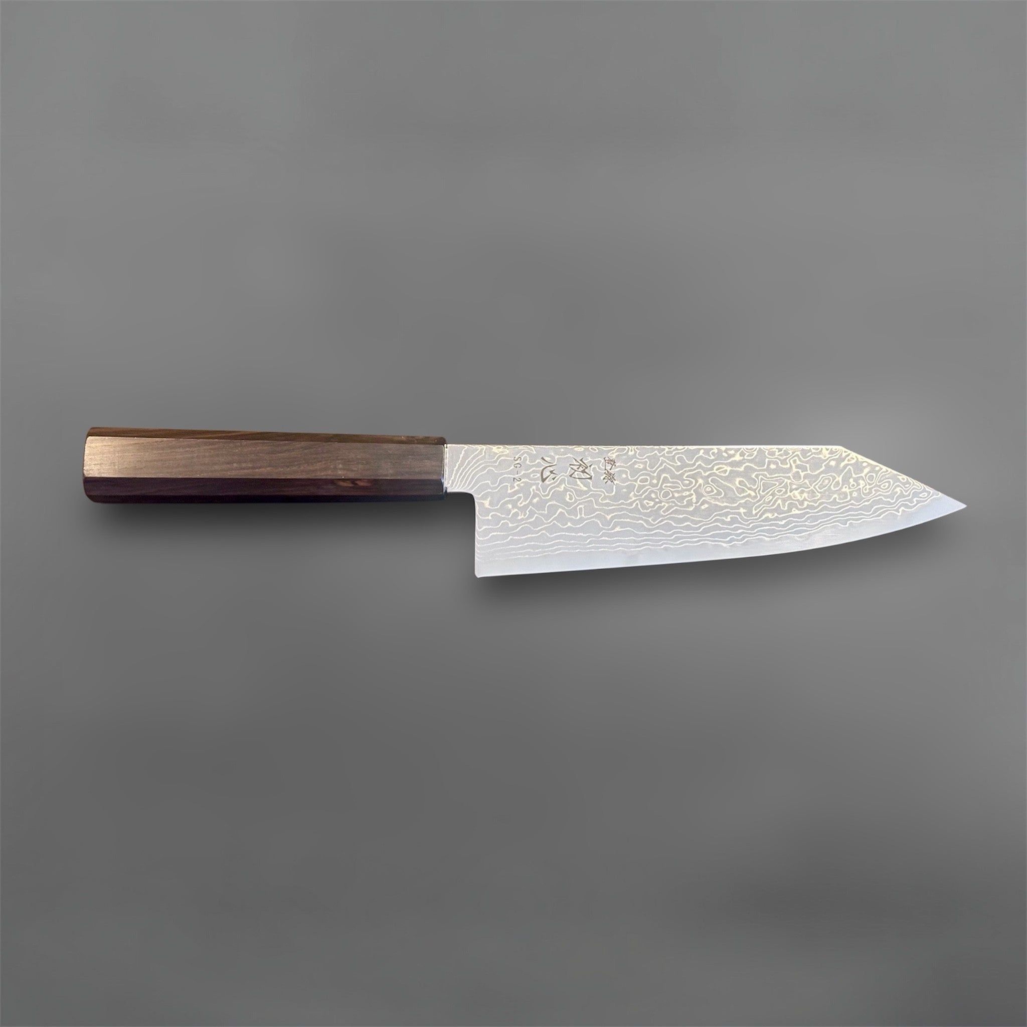 Hatsukokoro Ryuhyo SG2 Damascus Migaki Bunka with Mono Ebony Handle, full side profile of the blade and handle on a gray background.