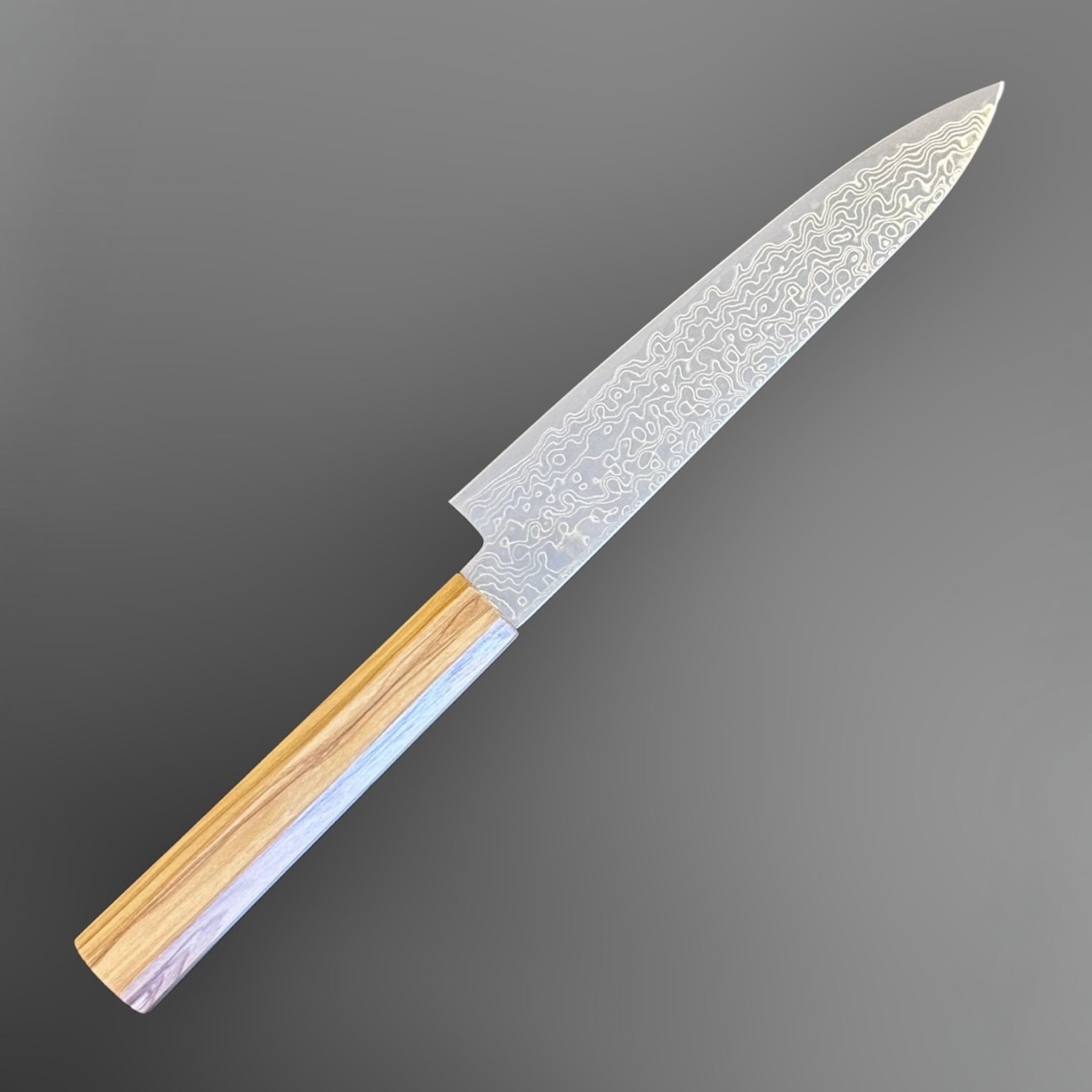 Hatsukokoro Ryuhyo SG2 Damascus Petty 150 mm with olive wood handle, close angled product shot showing the Damascus pattern and wa handle grain.