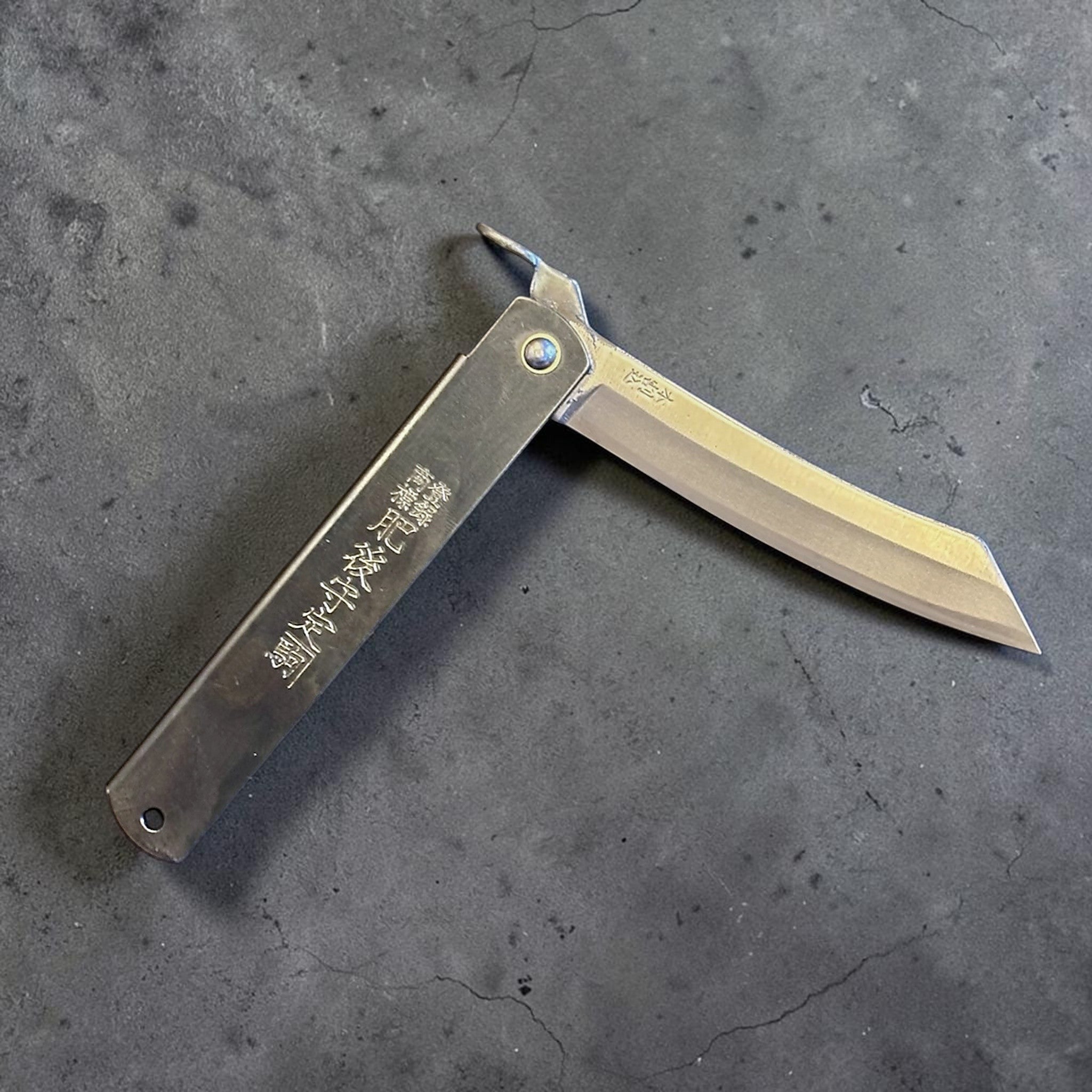 Higonokami Carbon Steel Japanese Friction Folder, three-quarter product view with blade partially open.