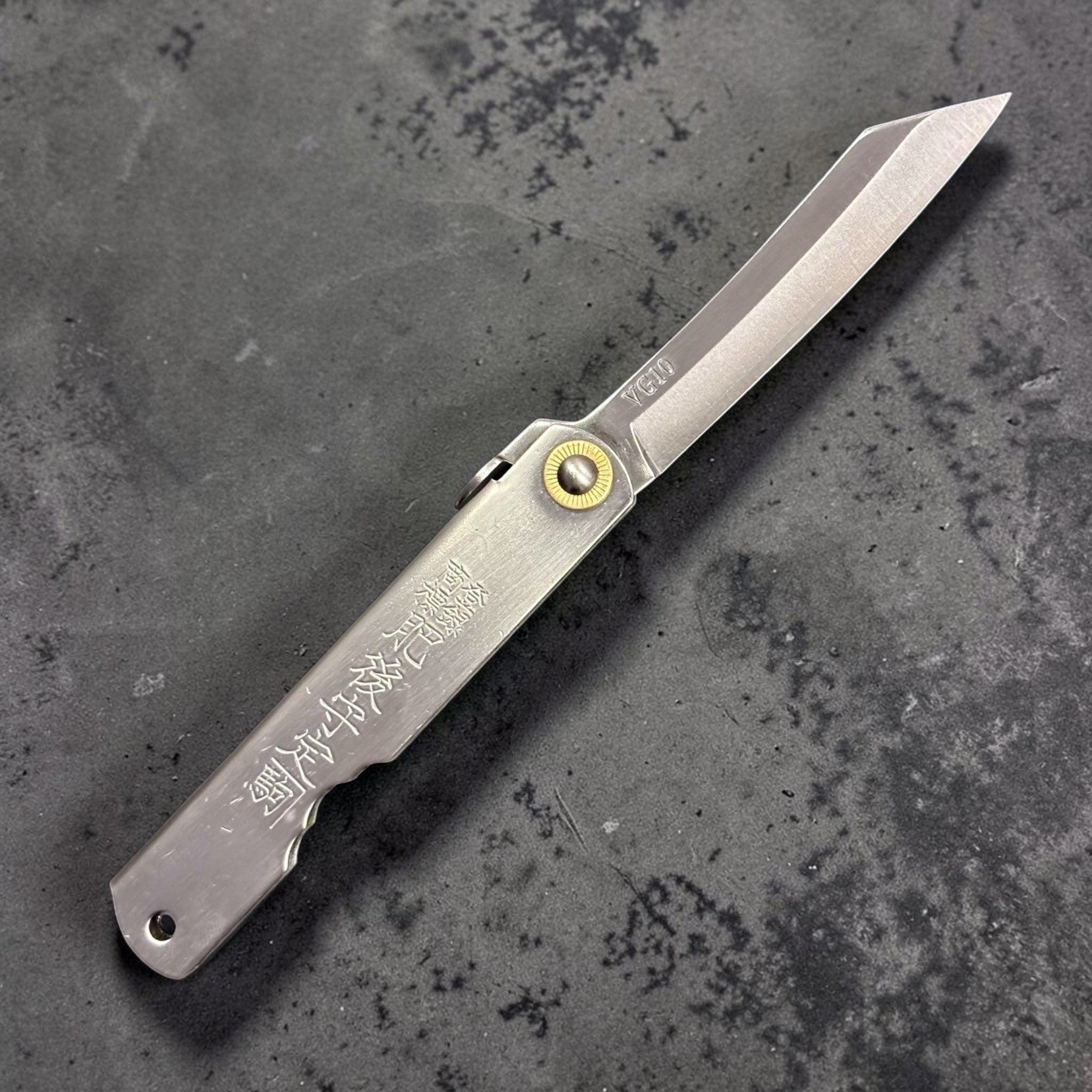 Front view of Higonokami VG-10 pocket knife showing kanji engraving on handle.