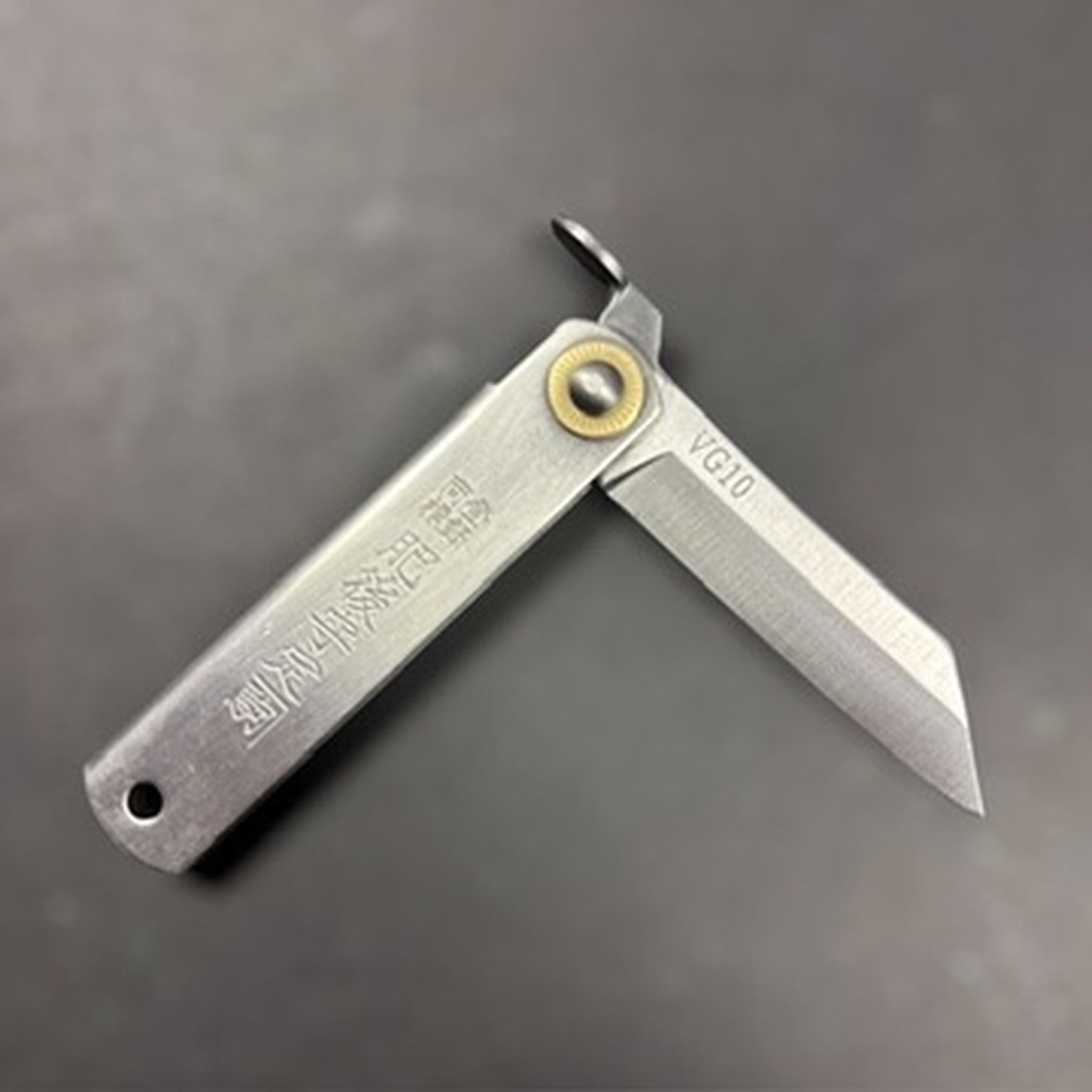 Higonokami VG‑10 Japanese pocket knife (Small), open at a right angle showing the kanji stamp and brass pivot.