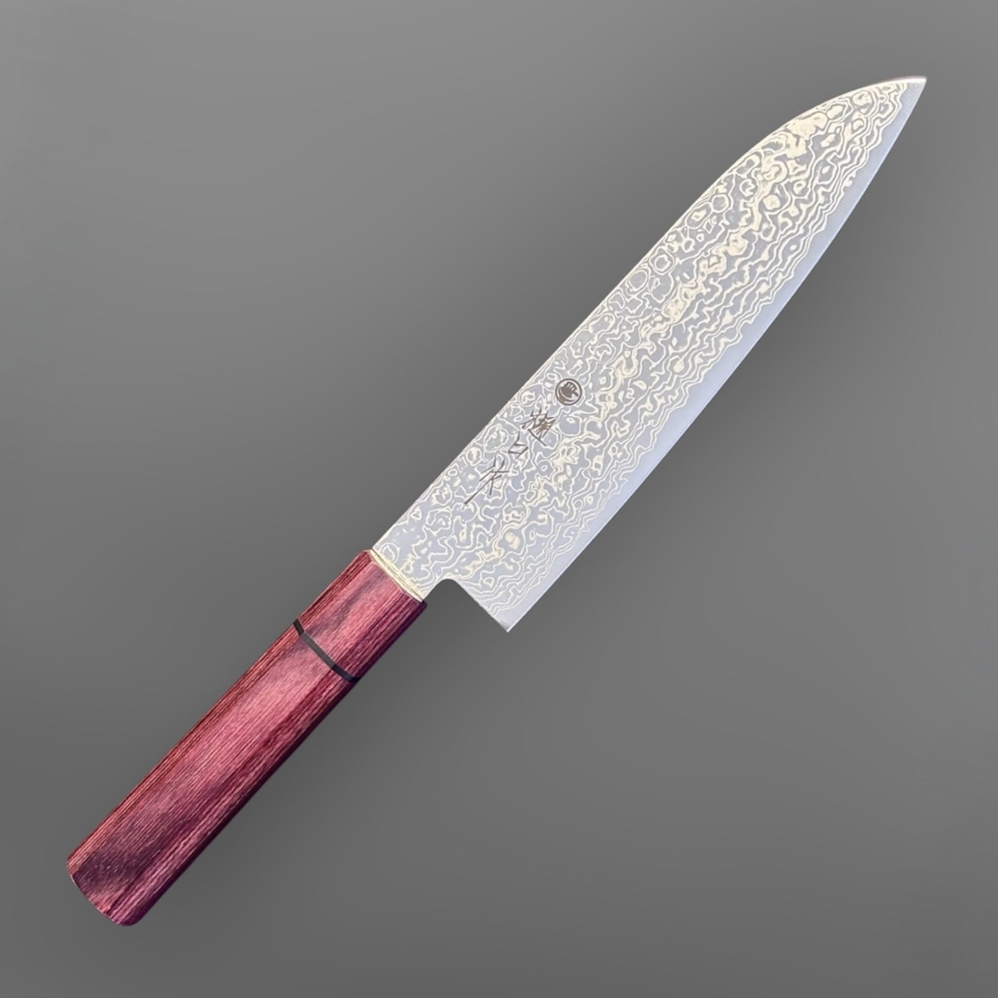 Higuchi SG2 Damascus Santoku 180 mm with red pakkawood handle, close-up angled view of the SG2 Damascus blade face.