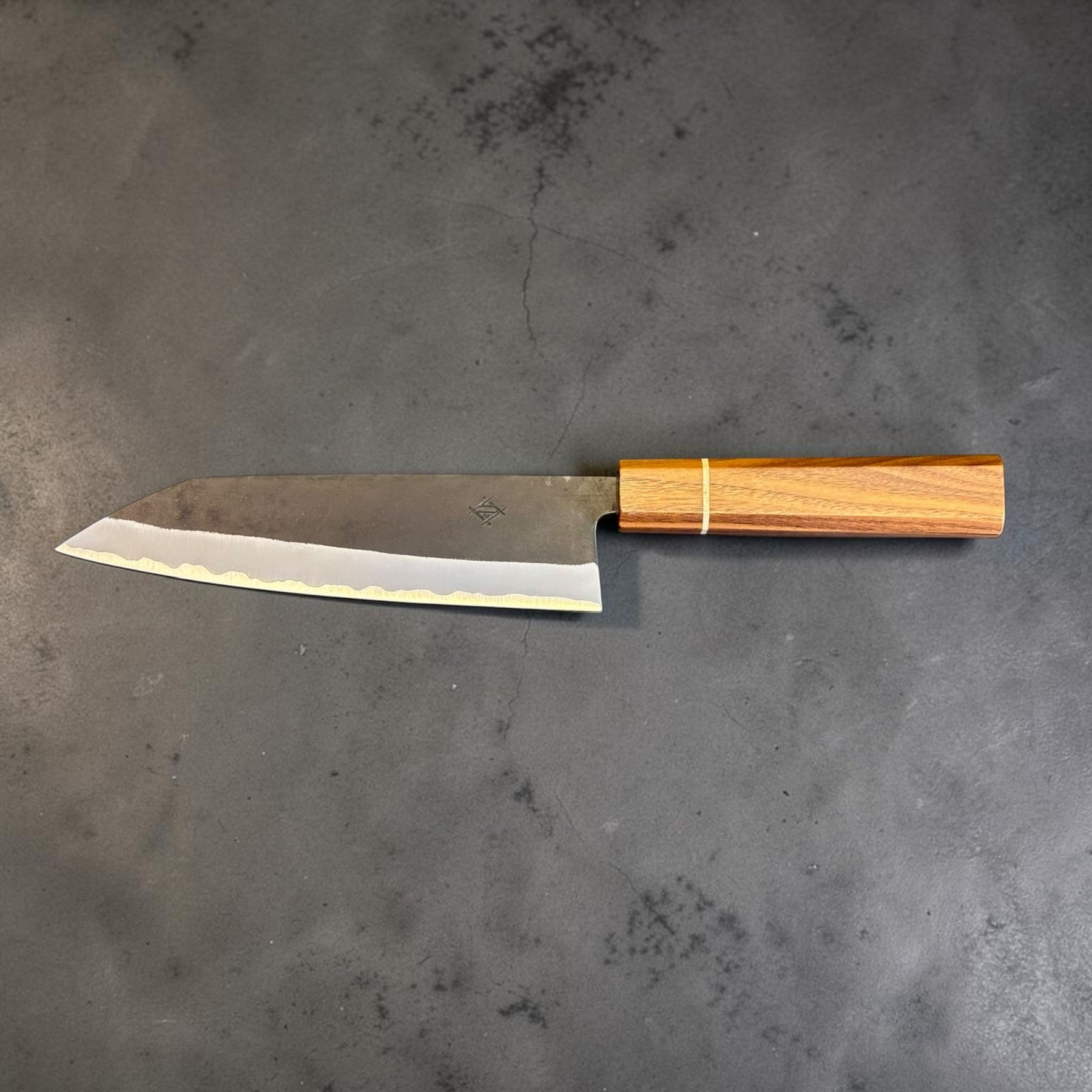 Full profile of the Imai Stainless Clad Aogami Super Kurouchi Bunka 183 mm with stainless cladding, Aogami Super core, kurouchi finish, and Sanjo walnut and maple stripe handle.