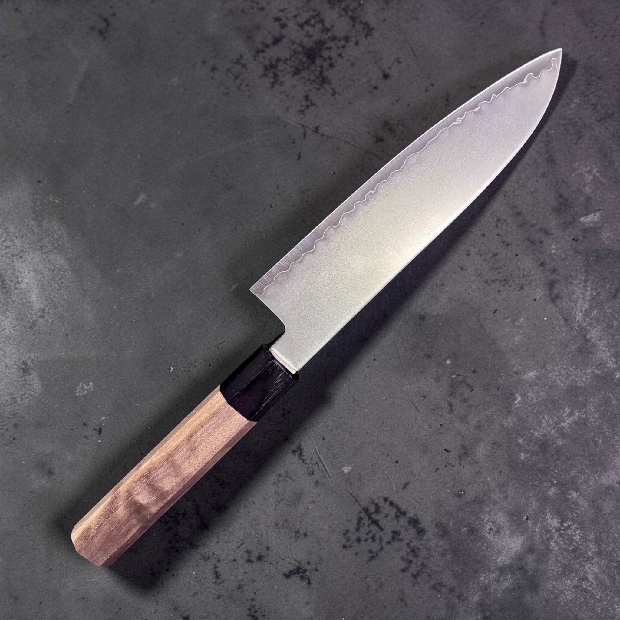 Kagekiyo Chromax Santoku 170 mm, left side profile highlighting the satin blade finish and wavy cladding line.