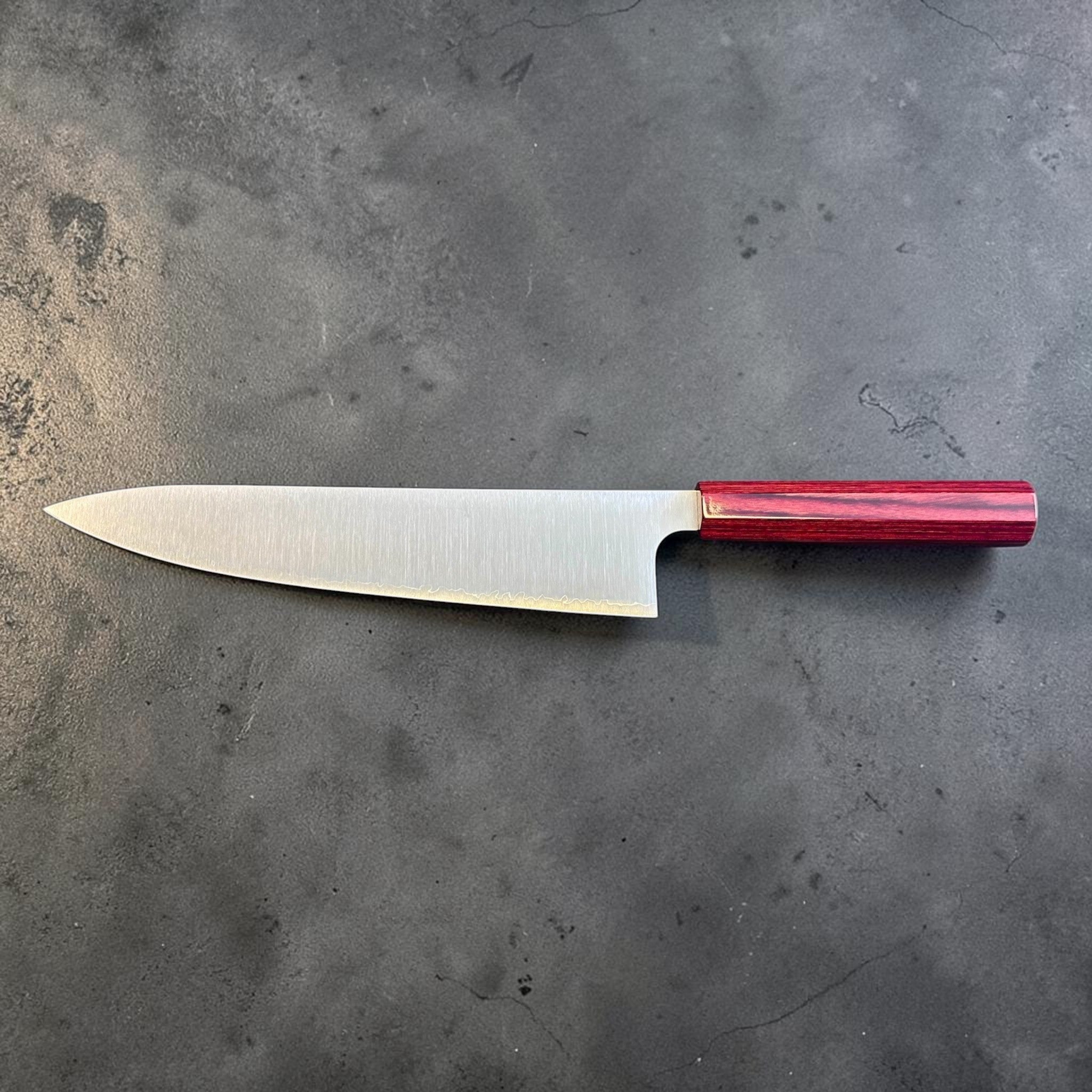 Kei Kobayashi SG2 Gyuto 240 mm with red lacquer handle, full reverse-side profile showing the sleek blade shape, satin finish, and red lacquer wa handle.