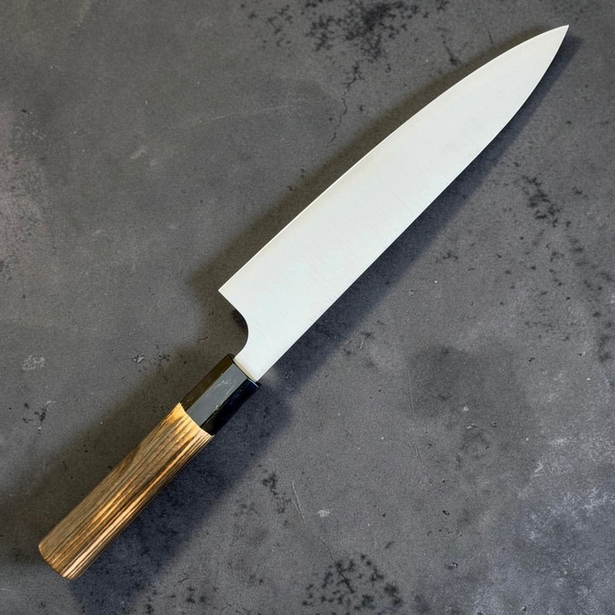 Reverse angled view of Kei Kobayashi SG2 Migaki Gyuto 210mm with burnt wood and black buffalo horn handle