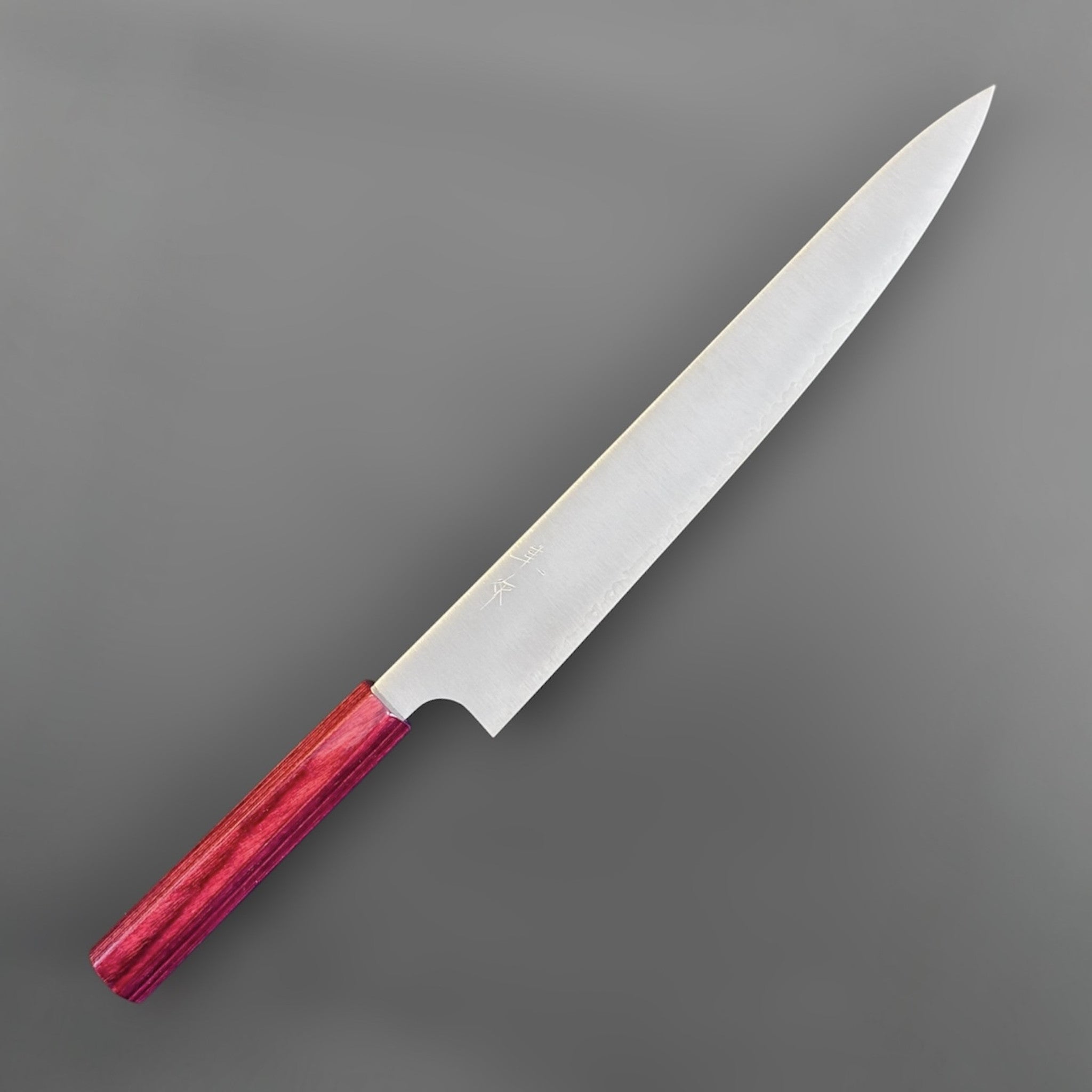 Kei Kobayashi SG2 Migaki Sujihiki 270 mm with red wa handle, angled front view highlighting the long slender blade and clean migaki finish.