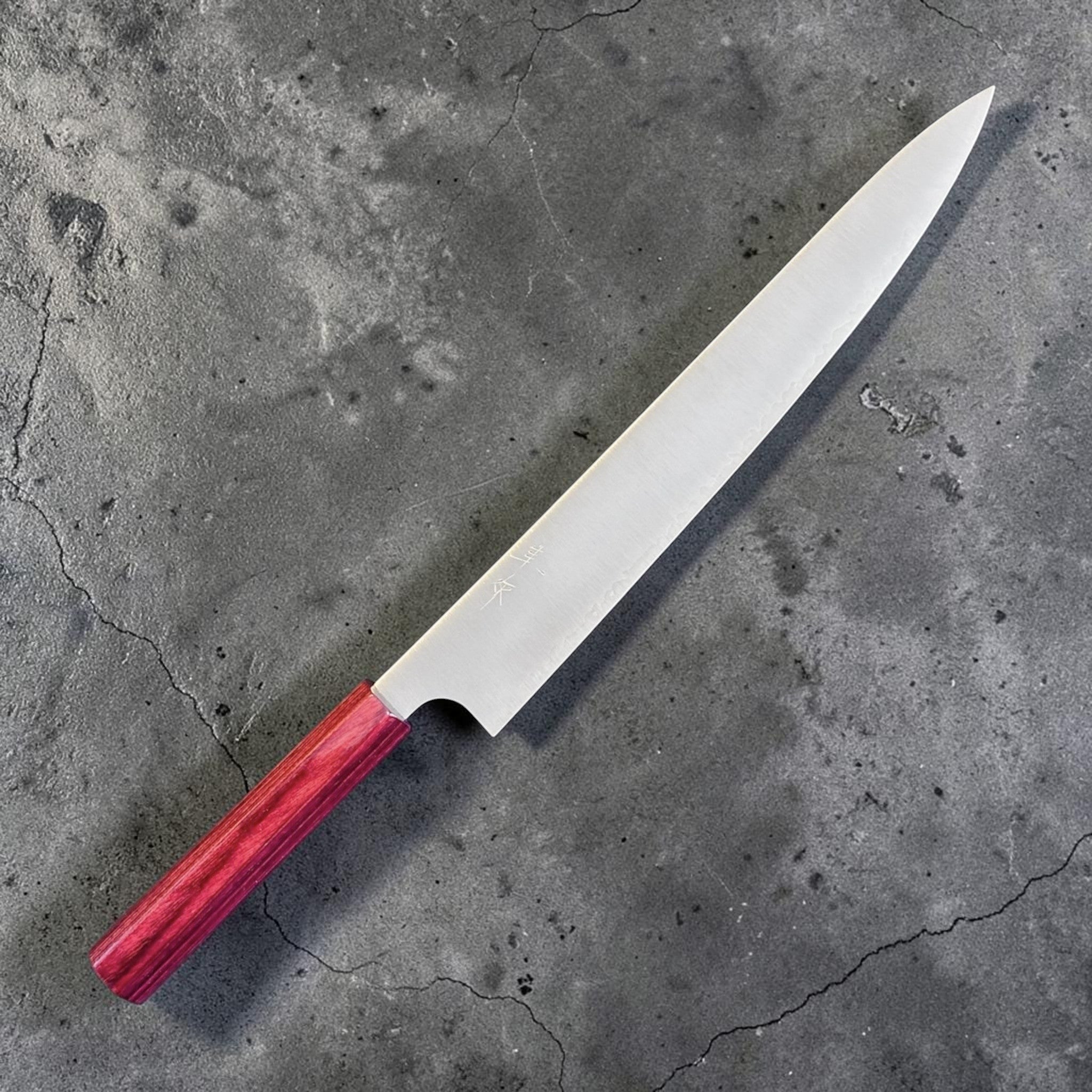 Kei Kobayashi SG2 Migaki Sujihiki 270 mm with red wa handle, angled front view highlighting the long slender blade and clean migaki finish.