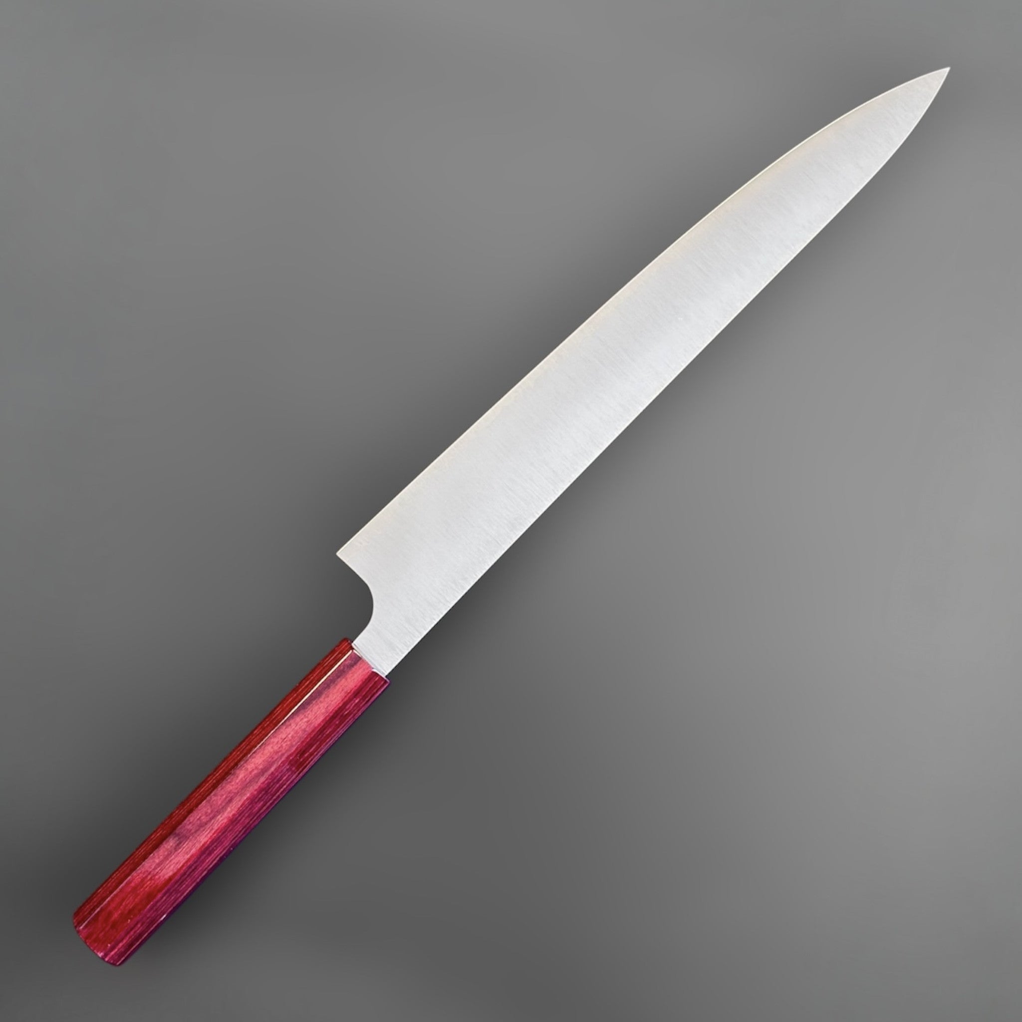 Kei Kobayashi SG2 Migaki Sujihiki 270 mm with red wa handle, angled reverse view showing the refined profile and satin blade finish.