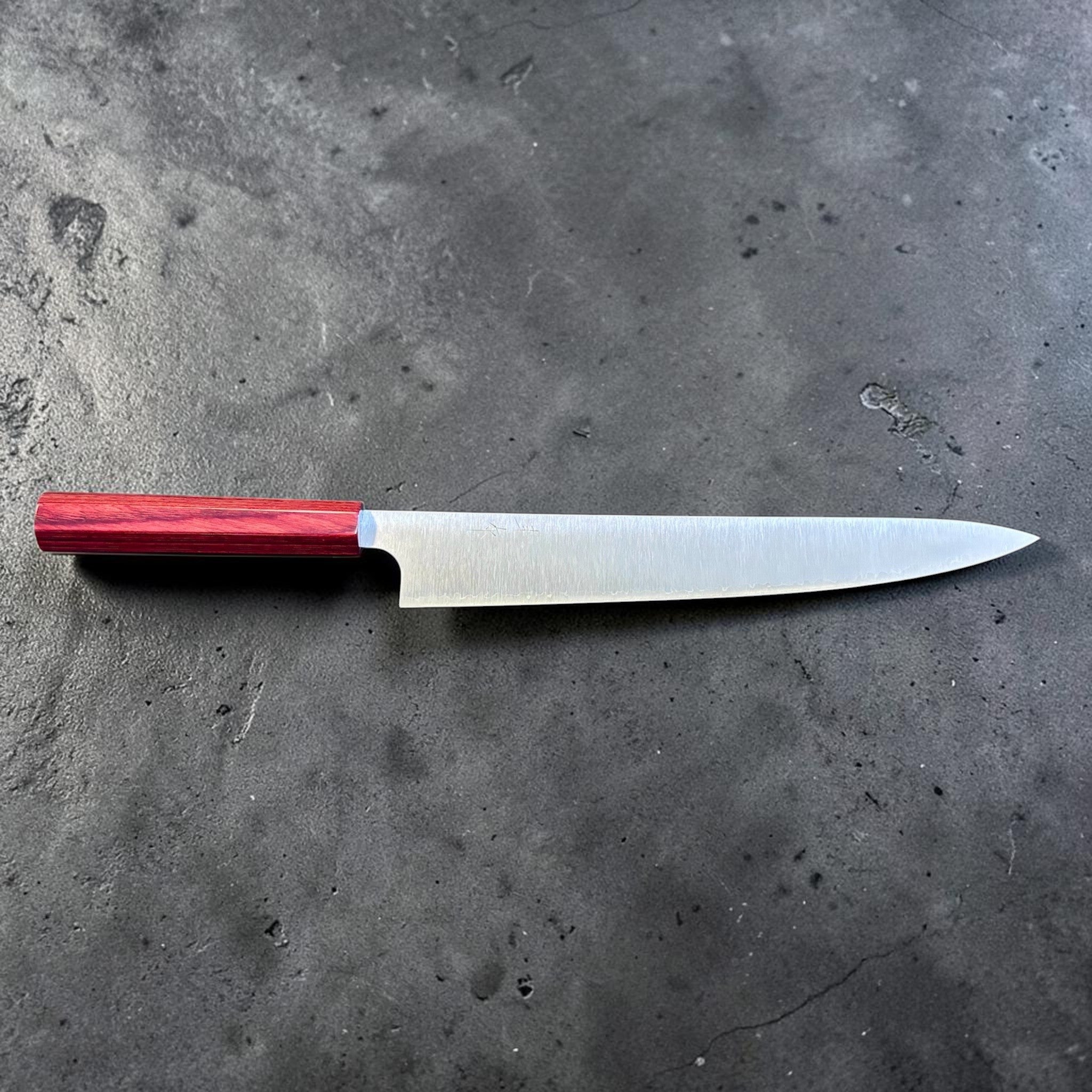 Kei Kobayashi SG2 Migaki Sujihiki 270 mm with red wa handle, full side profile showing the sweeping sujihiki edge and slim geometry.