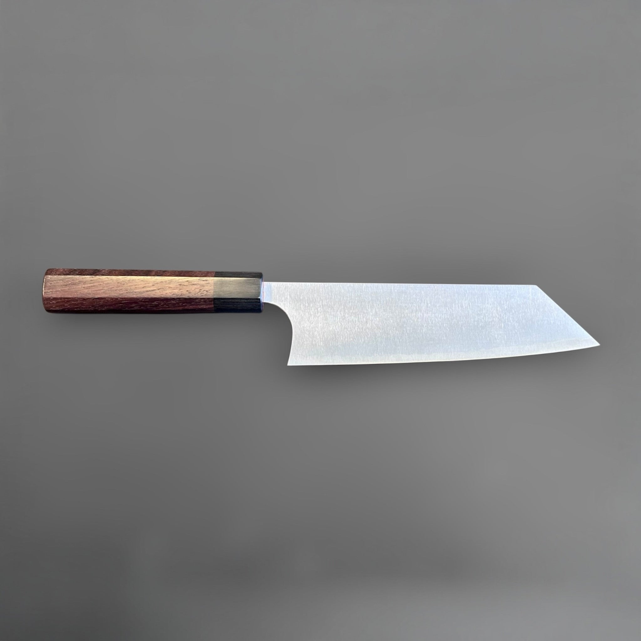 Koutetsu SG2 Bunka 180 mm with rosewood octagonal handle, full side profile highlighting the reverse side of the blade and compact bunka shape.