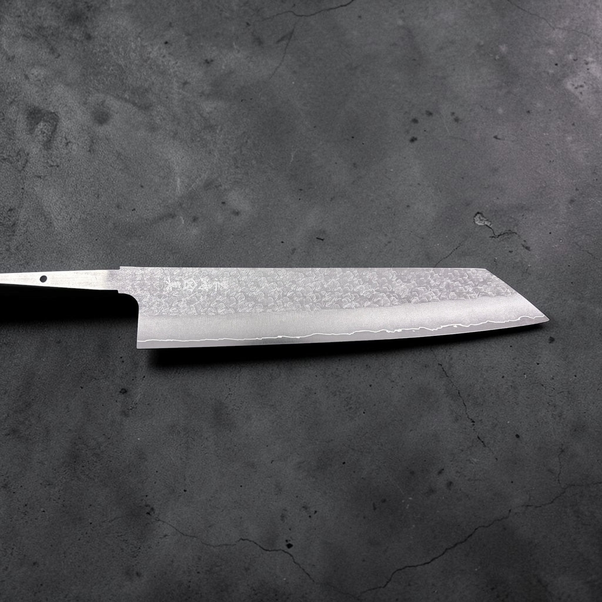 Makoto Kurosaki VG-XEOS Tsuchime Bunka 240 mm, full blade shot without handle against a neutral grey background.