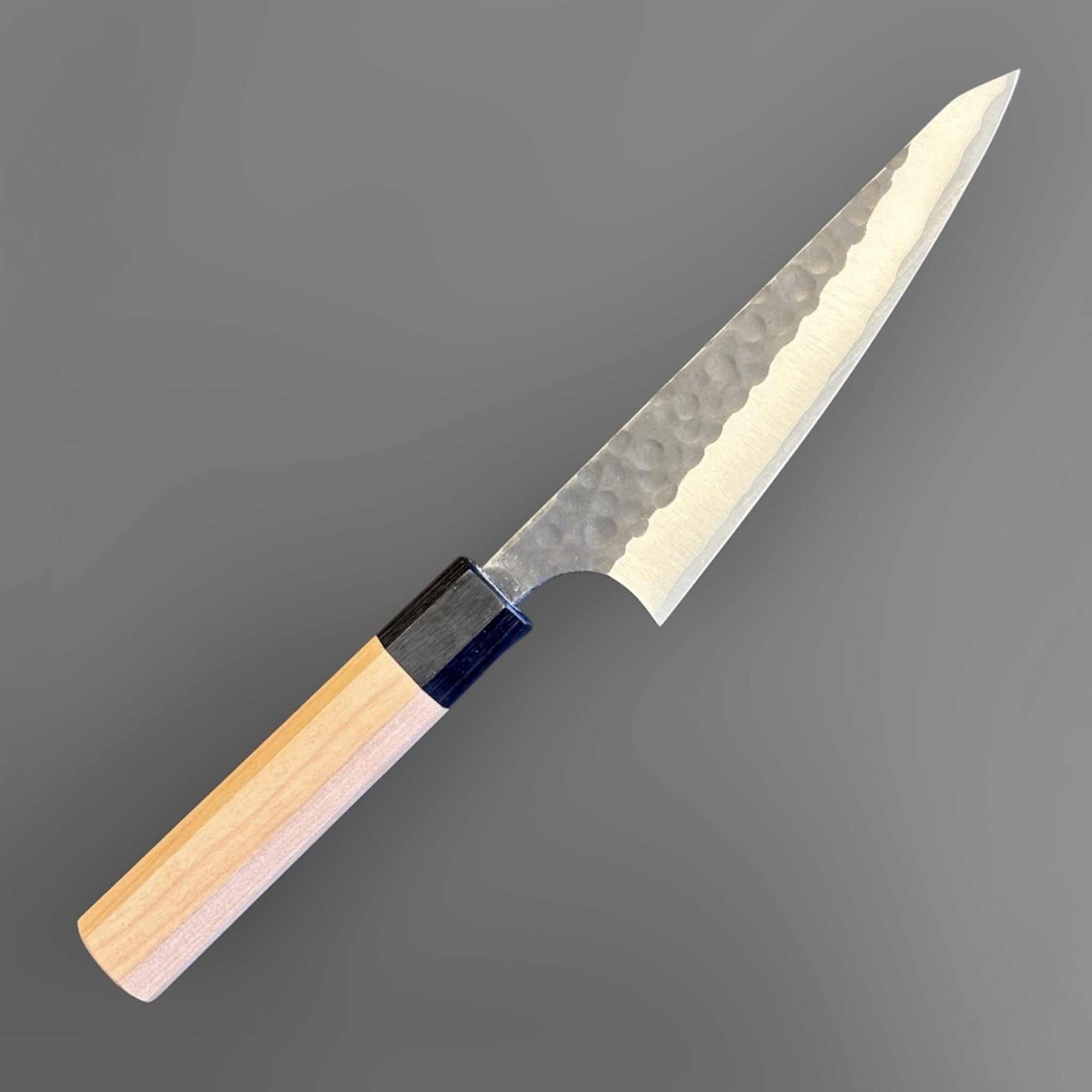 Masakage Koishi Honesuki Japanese knife, angled reverse-side product view with pointed triangular profile and octagonal wa handle.
