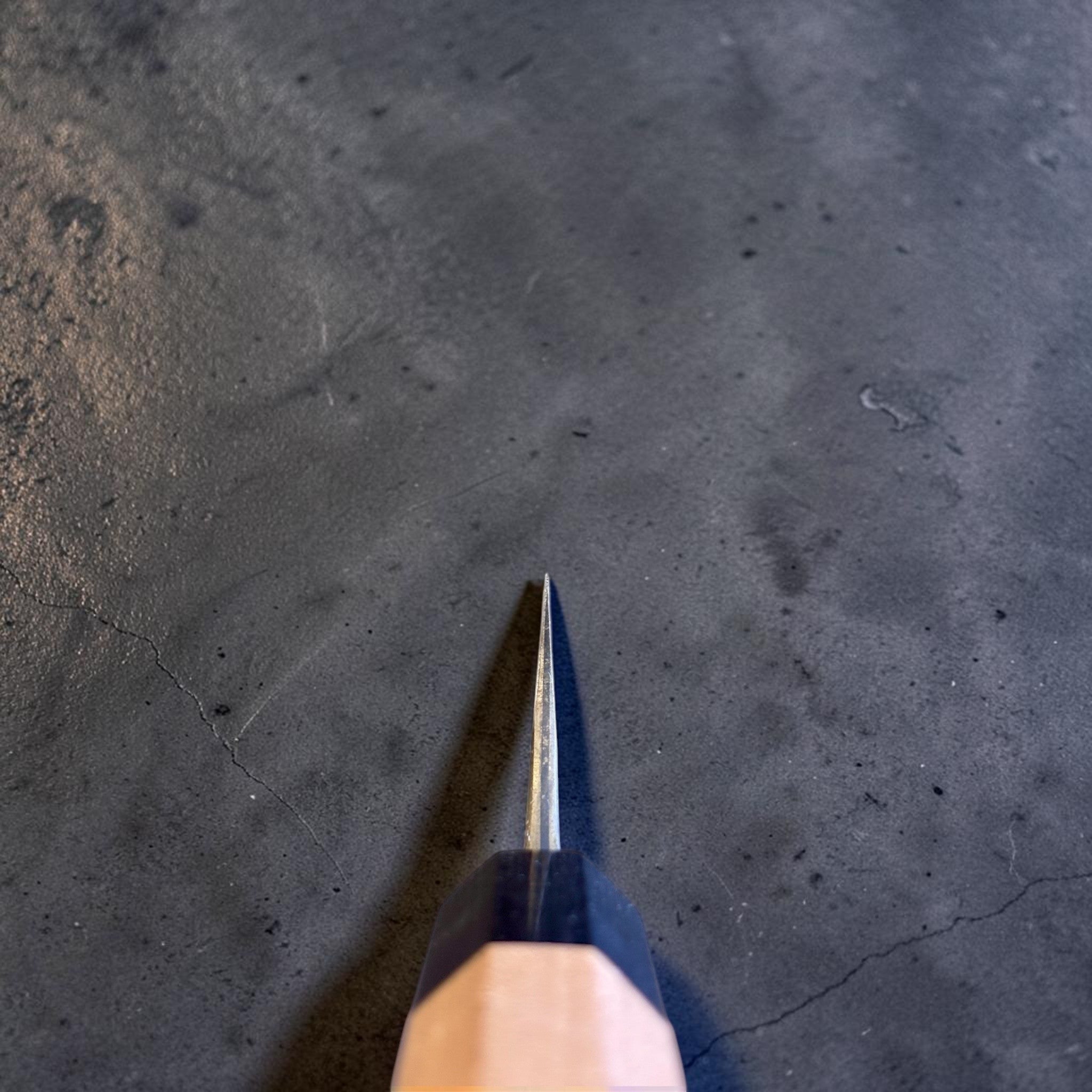 Masakage Koishi Honesuki Japanese knife, spine view showing the blade thickness taper toward the tip.