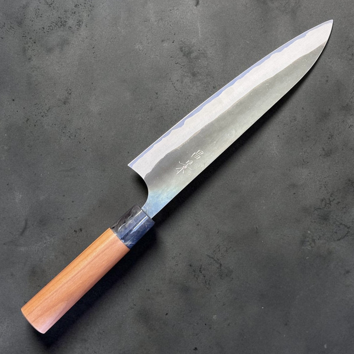 Masakage Mizu Gyuto 210 mm, angled blade face view showing the kurouchi-style Mizu finish and kanji.