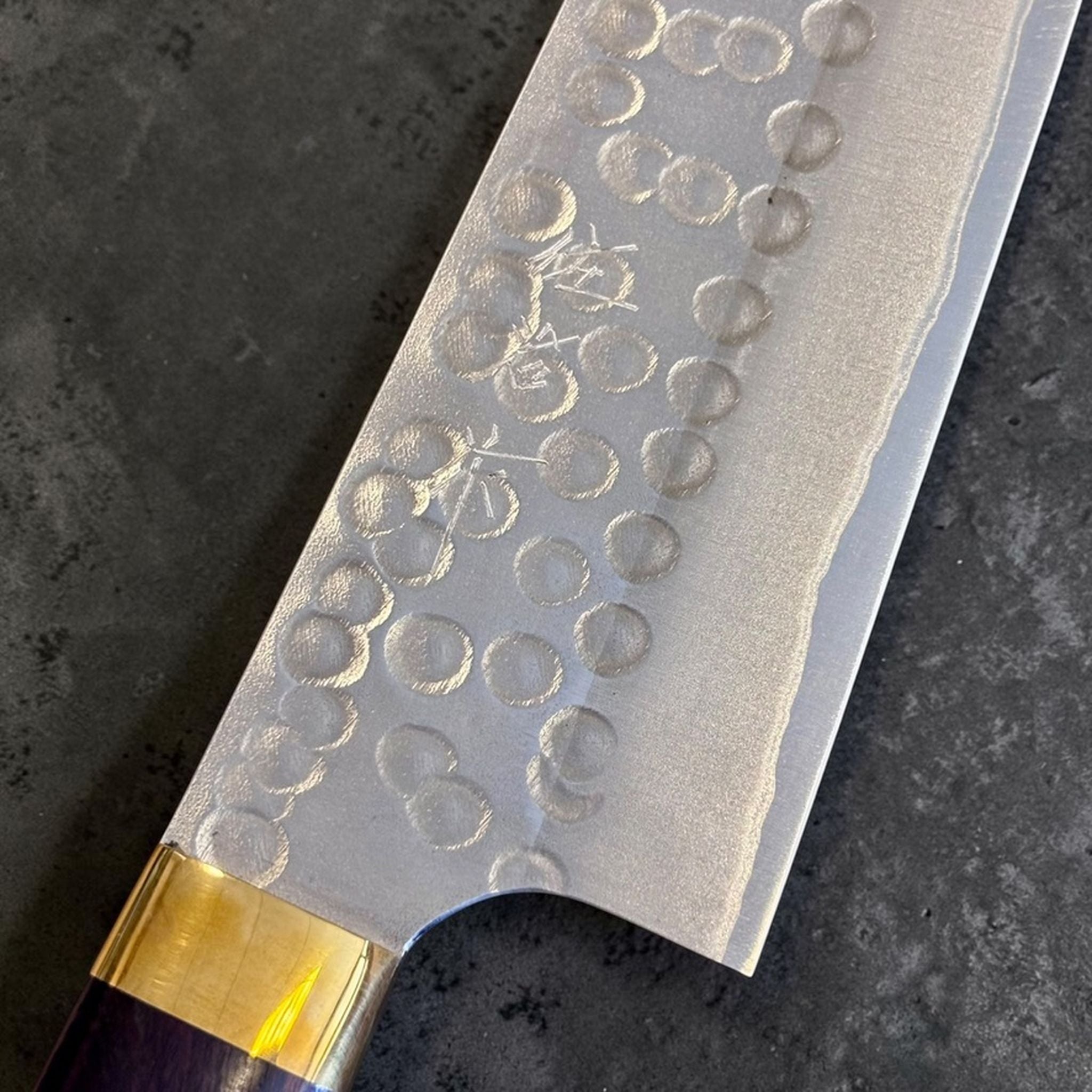 Masakage Zero Gyuto 210 mm, close-up of hammered blade texture, maker marks, and gold bolster.
