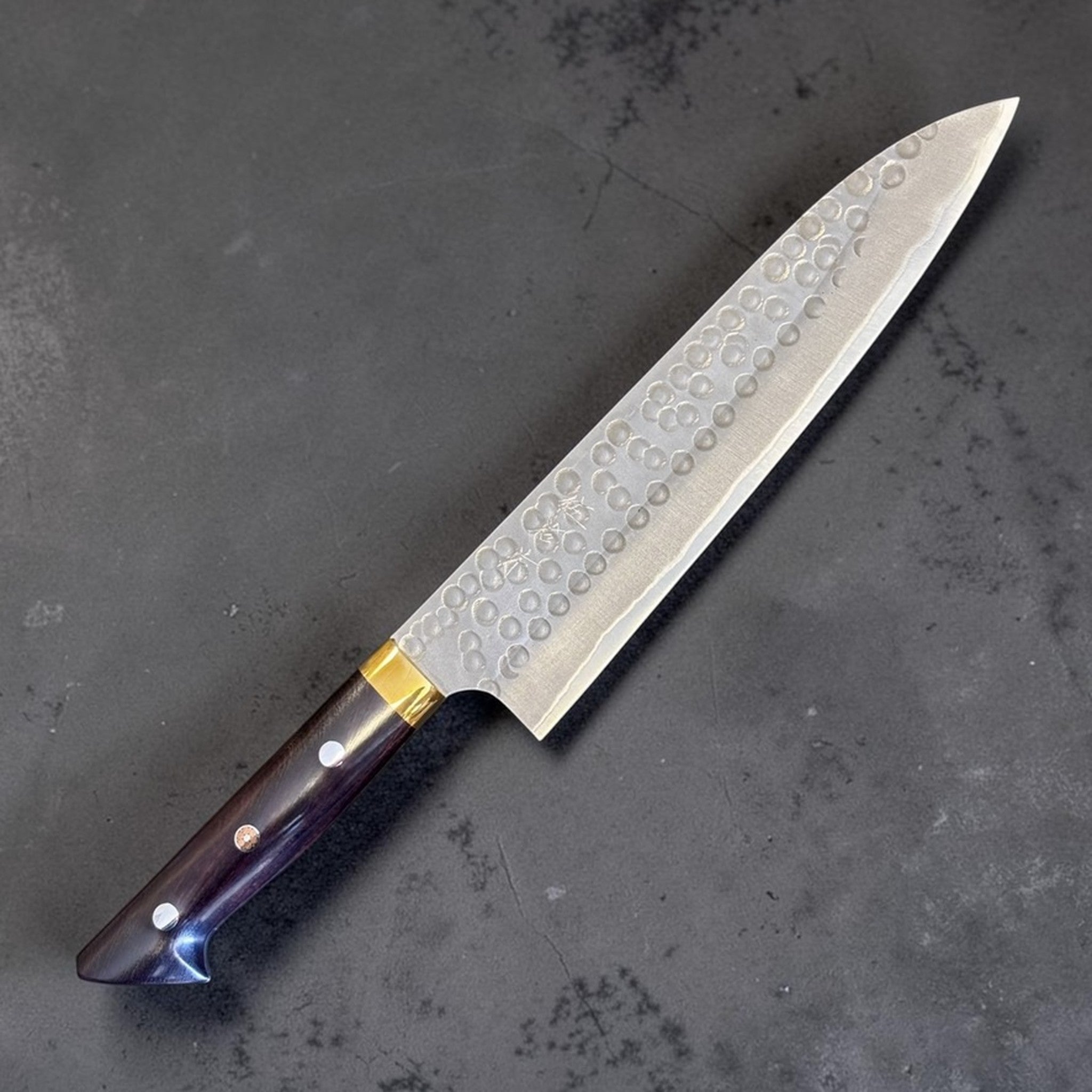 Masakage Zero Gyuto 210 mm, angled product view highlighting blade profile, hammered finish, and handle detail.