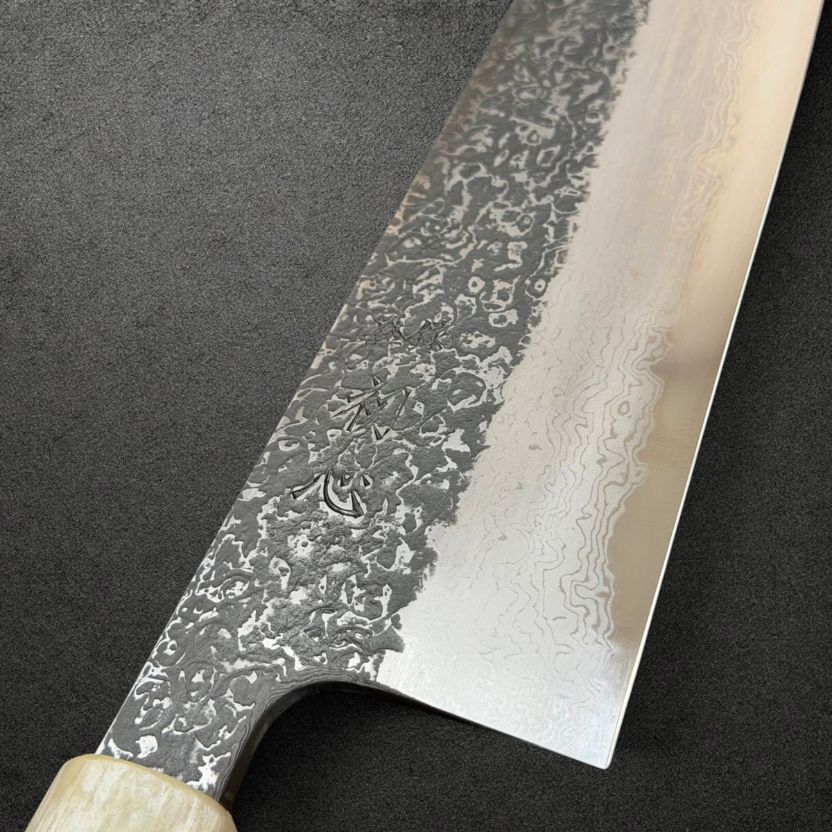 Close-up of Masuda engraving and contrasting Kurozome Damascus blade layers