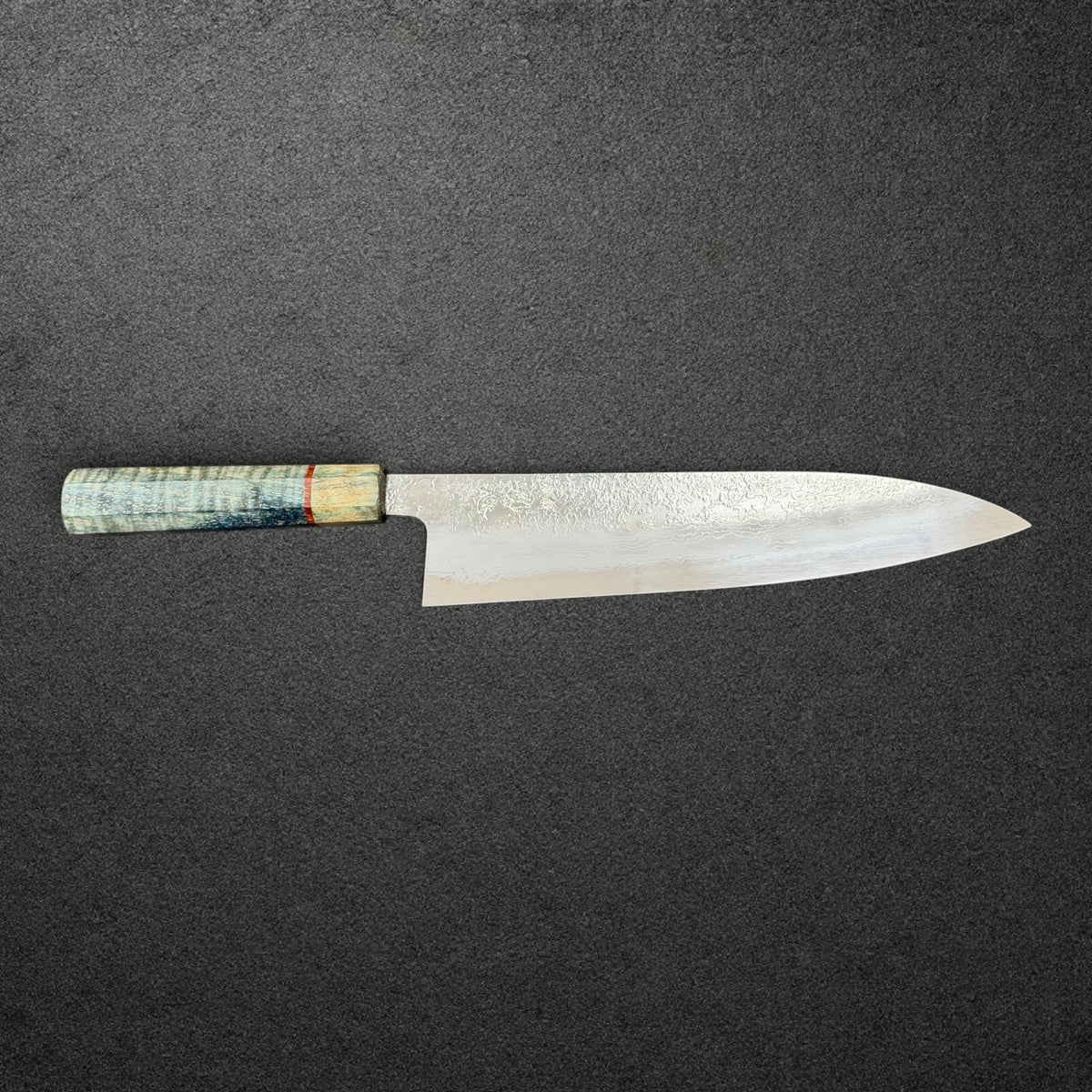 Masuda 240mm Migaki Damascus gyuto side profile with blue-green figured Prisma handle and red spacer