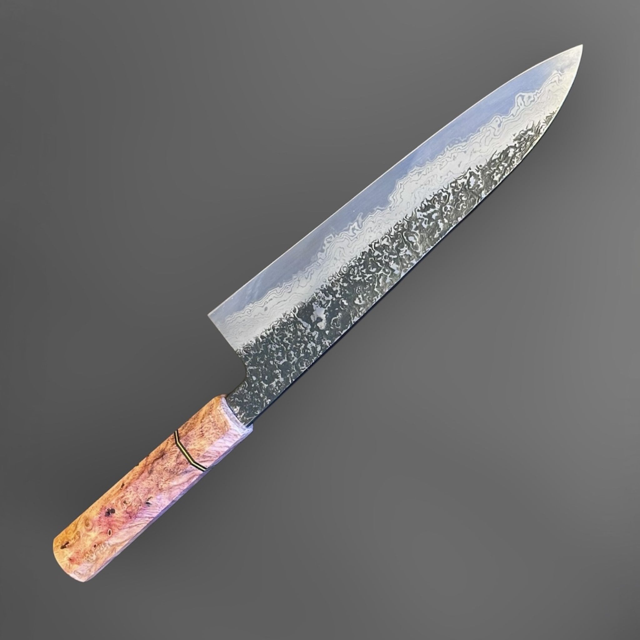 Masuda Yoshihide Blue #1 Kurozome Damascus Gyuto 210 mm with Prisma Knife custom handle, full angled profile showing the dark etched Damascus blade and warm figured handle.