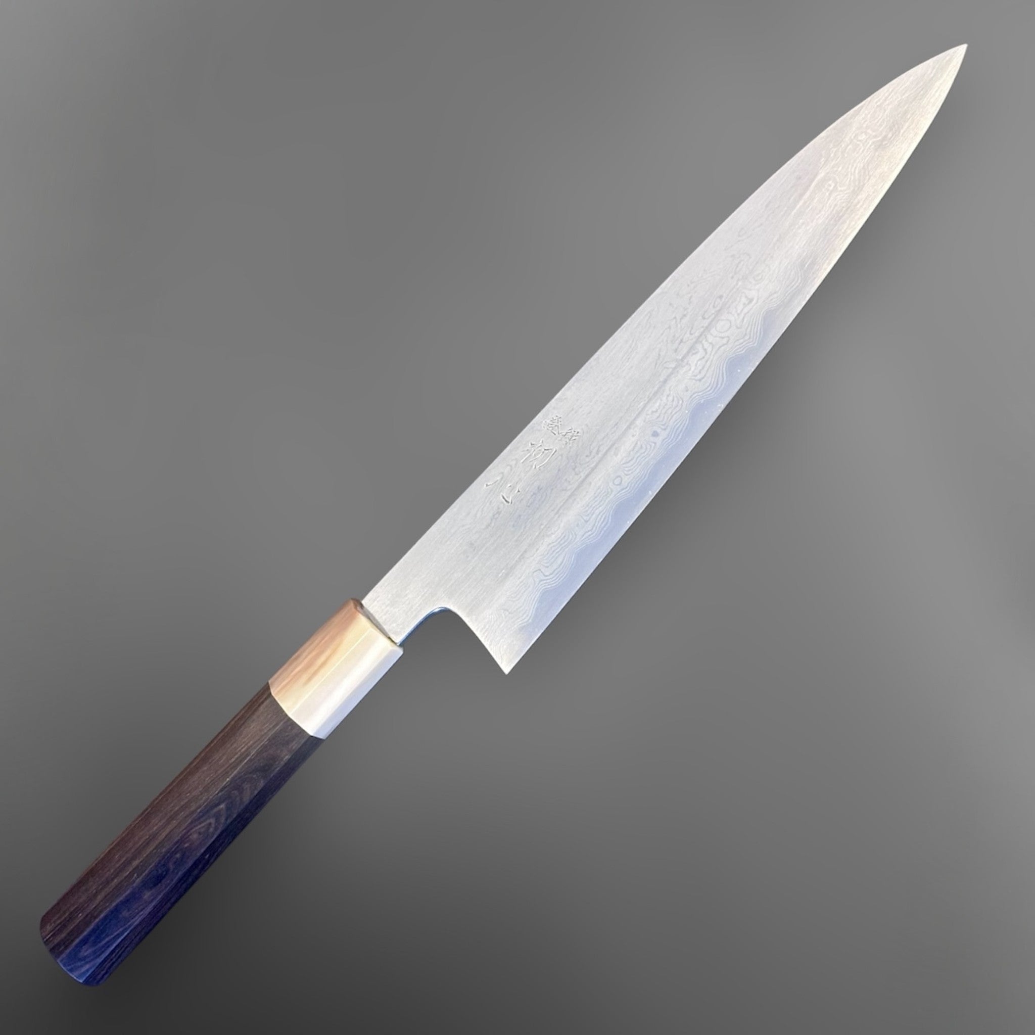 Nakagawa Satoshi Blue #1 Damascus Gyuto 225 mm with ebony and horn handle, alternate angled view highlighting Damascus pattern.