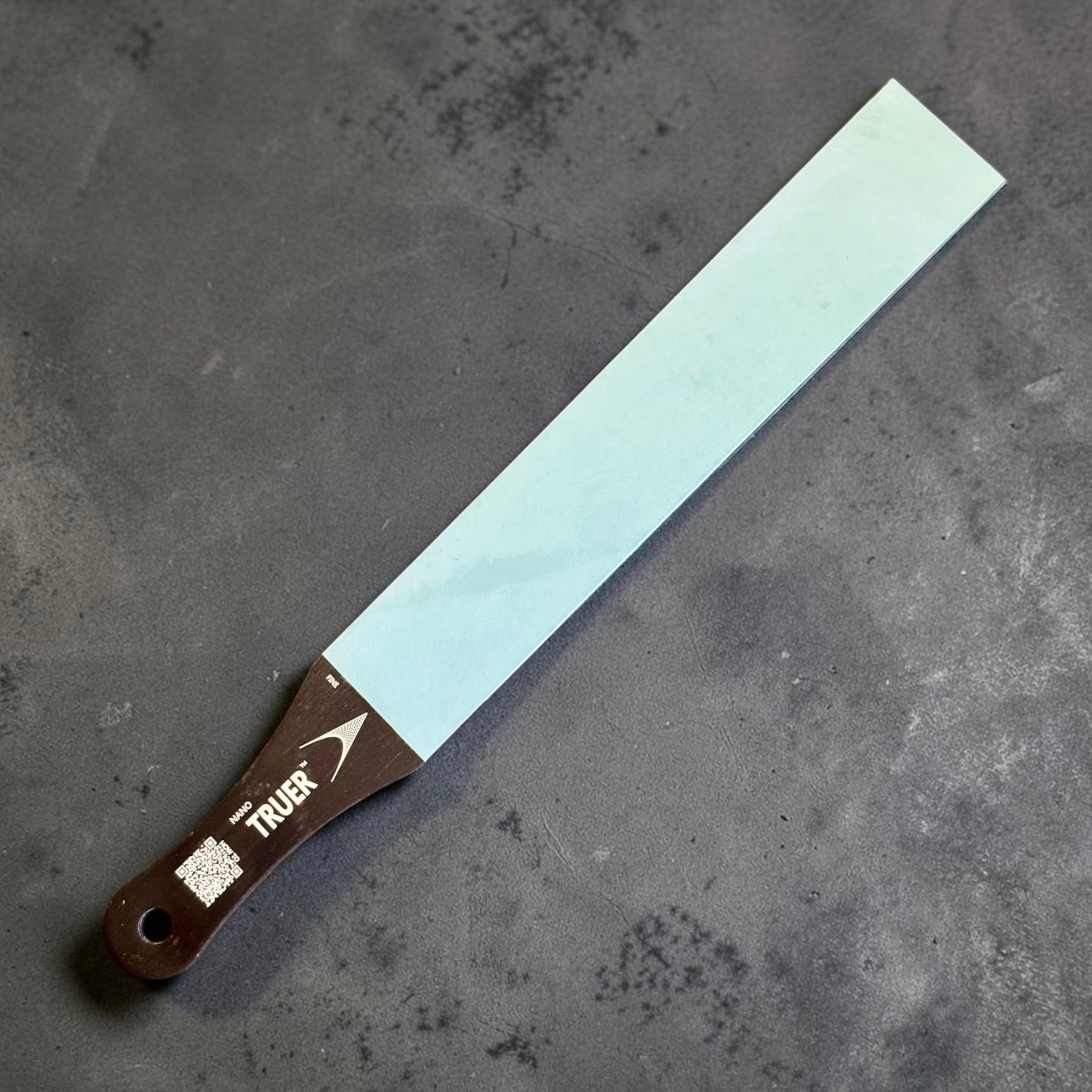 Nano Hone Truer 3/50 paddle strop showing the light blue 3 micron fine diamond resin side