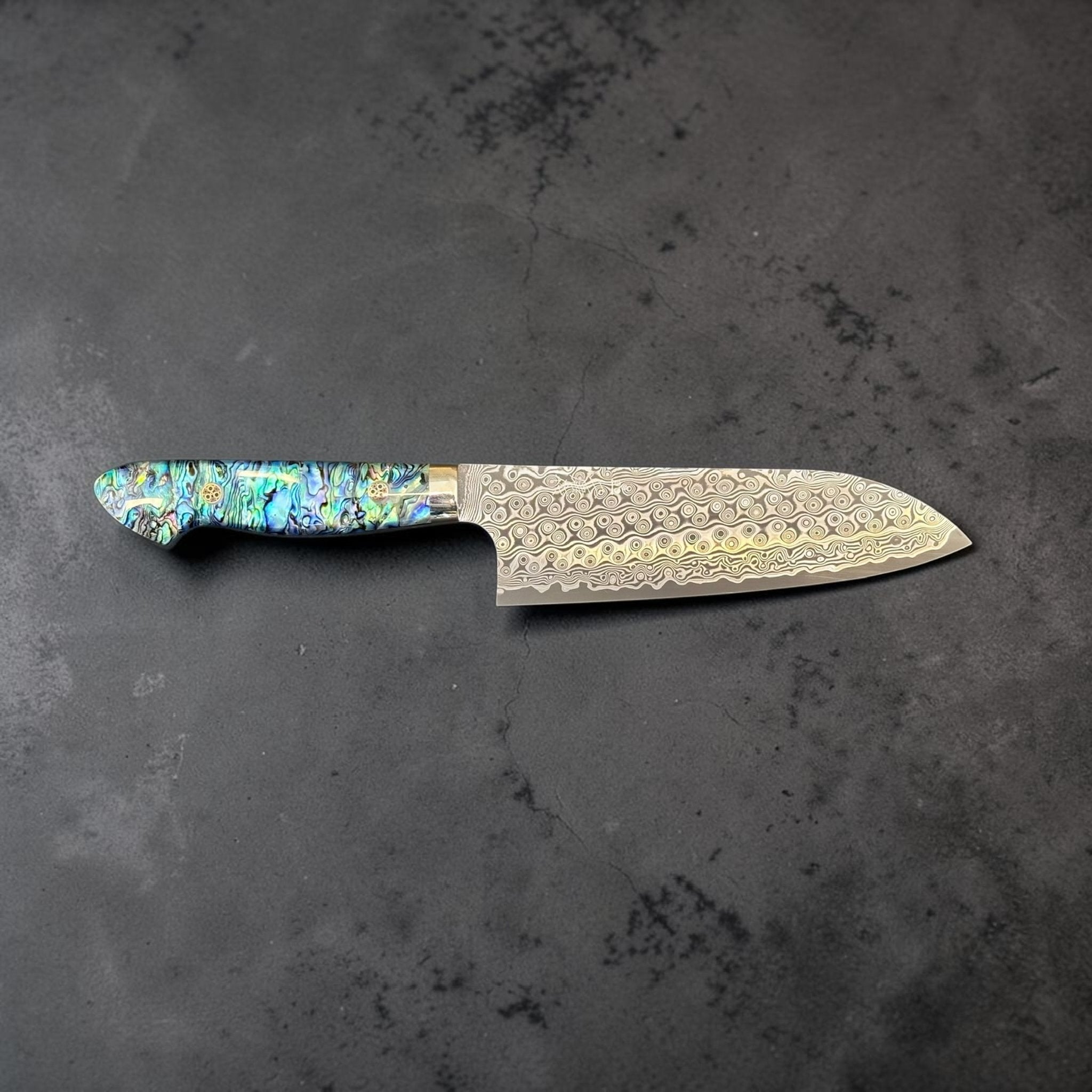 Nigara Anmon Damascus Santoku SG2 180 mm with Abalone Western Handle, full profile view showing Anmon Damascus santoku blade and abalone western handle.