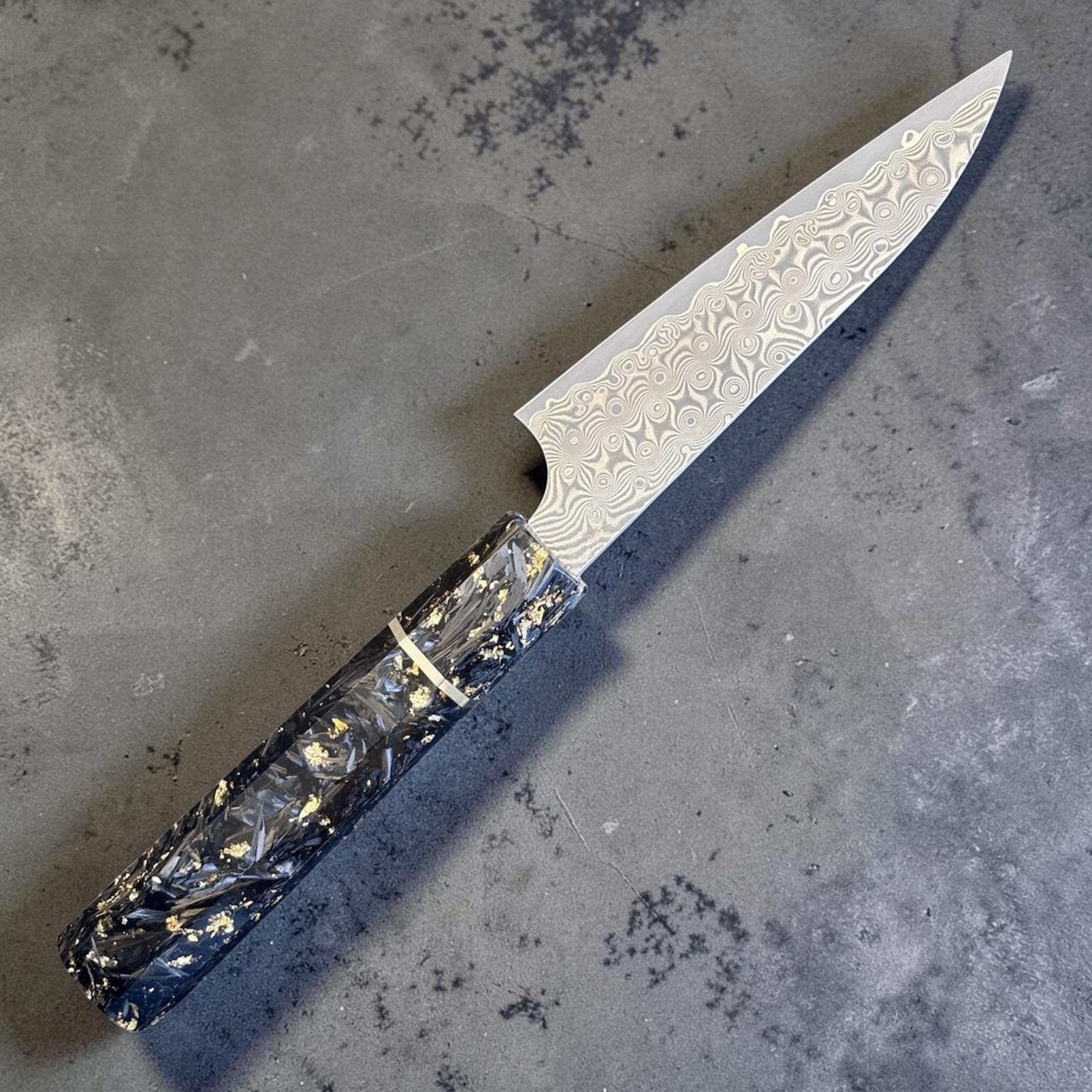 Nigara Anmon SG2 Petty 120 mm with carbon fiber and gold fleck handle, alternate angled view highlighting the blade pattern.