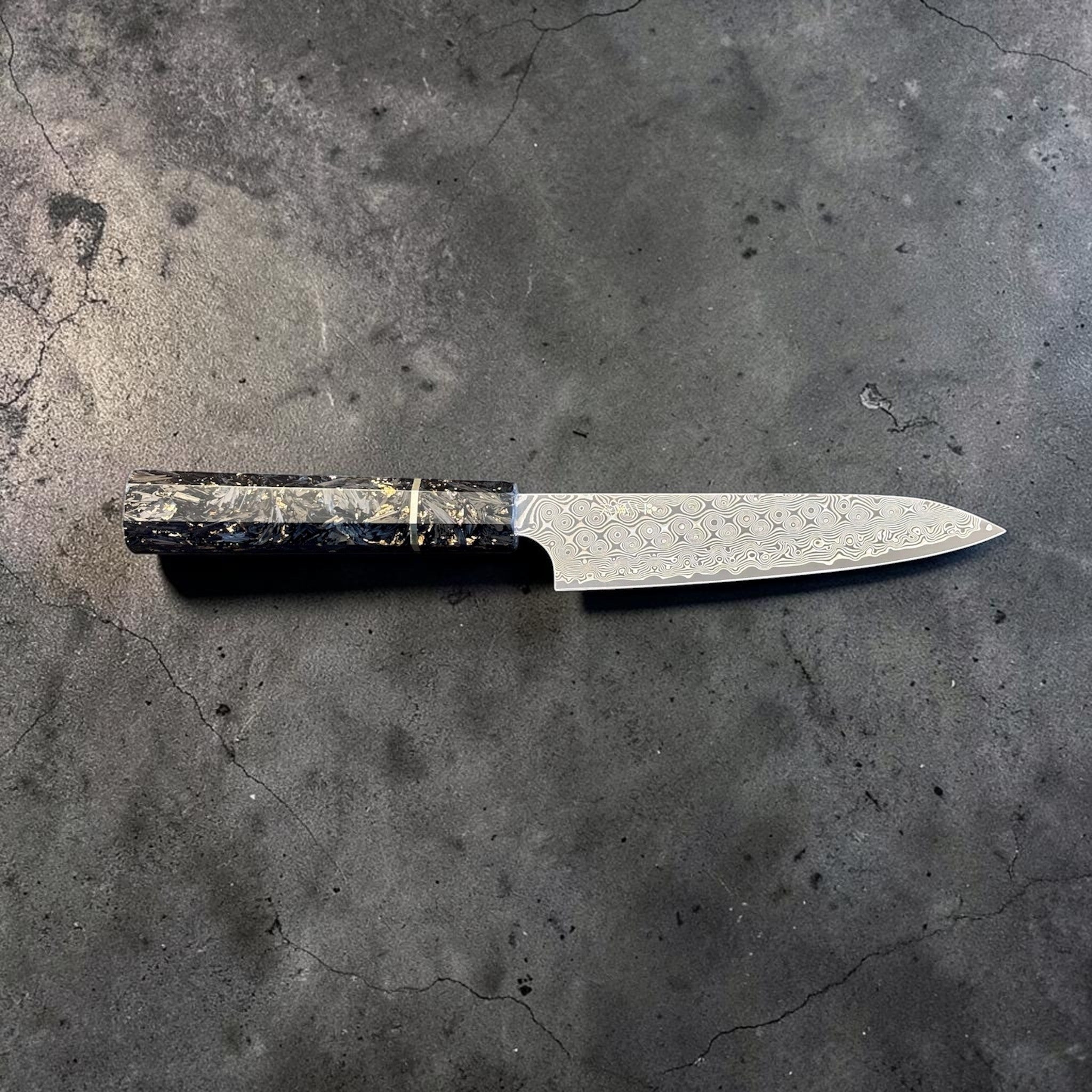 Nigara Anmon SG2 Petty 150 mm with carbon fiber and gold fleck handle, full horizontal profile view.