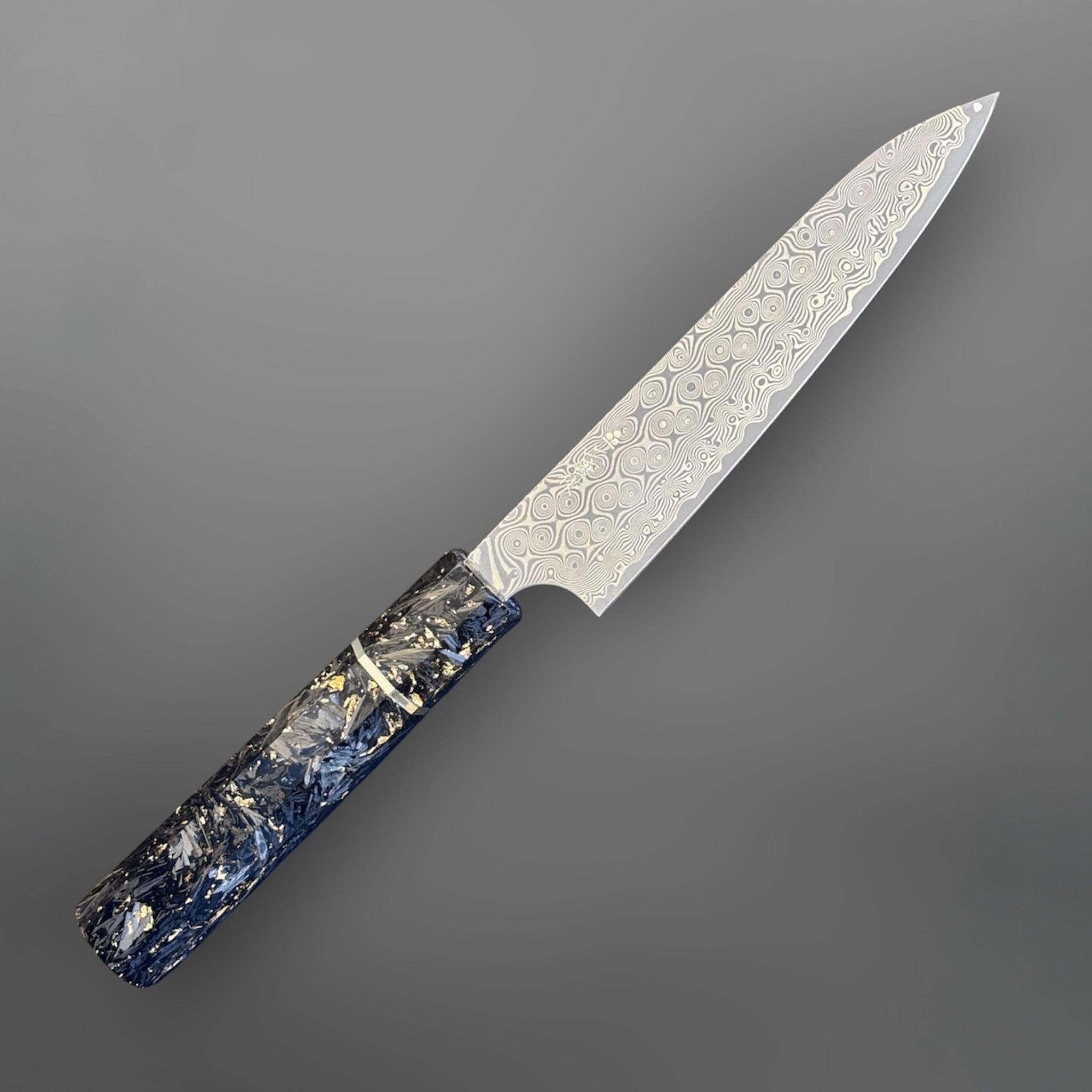 Nigara Anmon SG2 Petty 150 mm with carbon fiber and gold fleck handle, alternate angled view highlighting the damascus blade pattern.