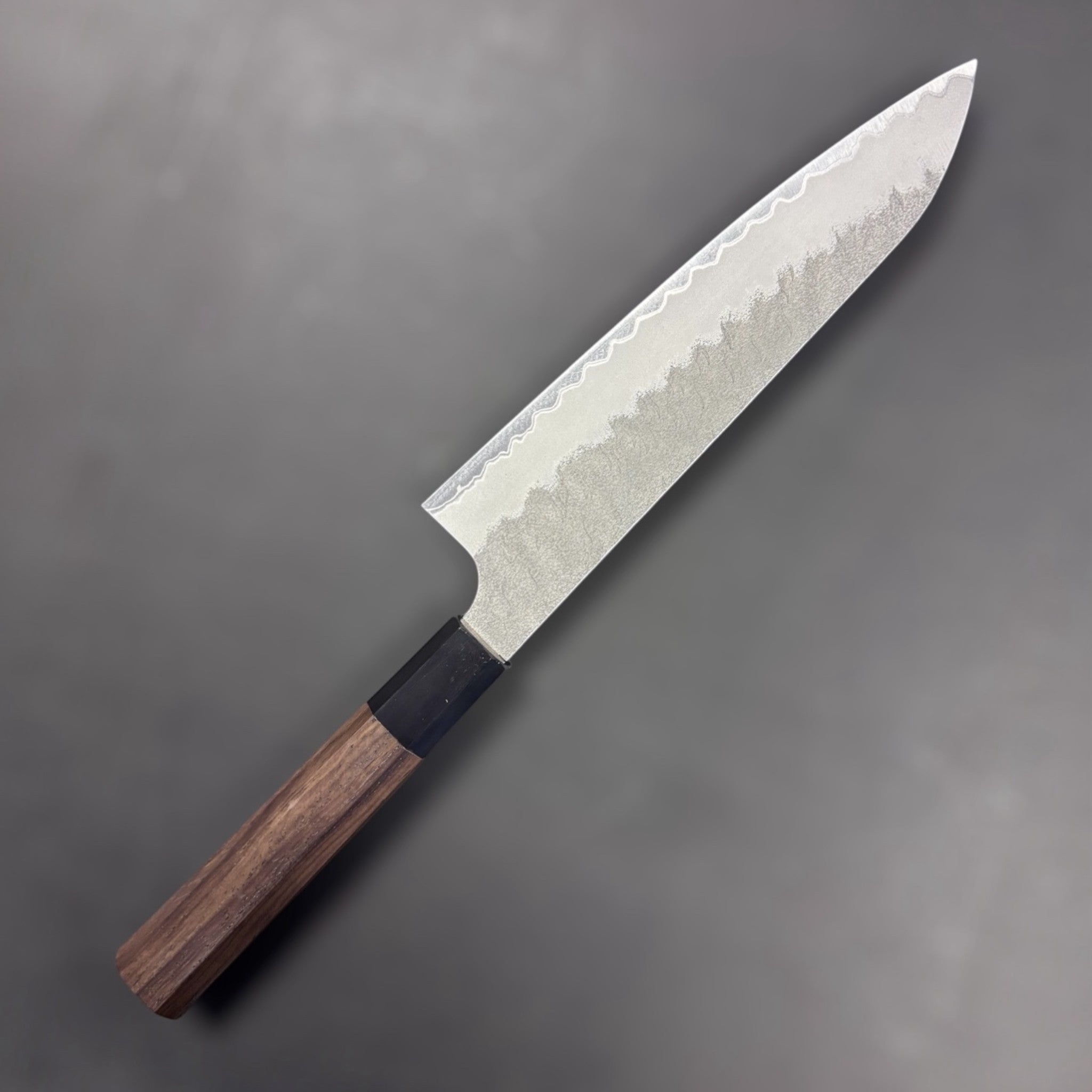 Nigara Aogami Super Gyuto 210mm on a grey background left side.