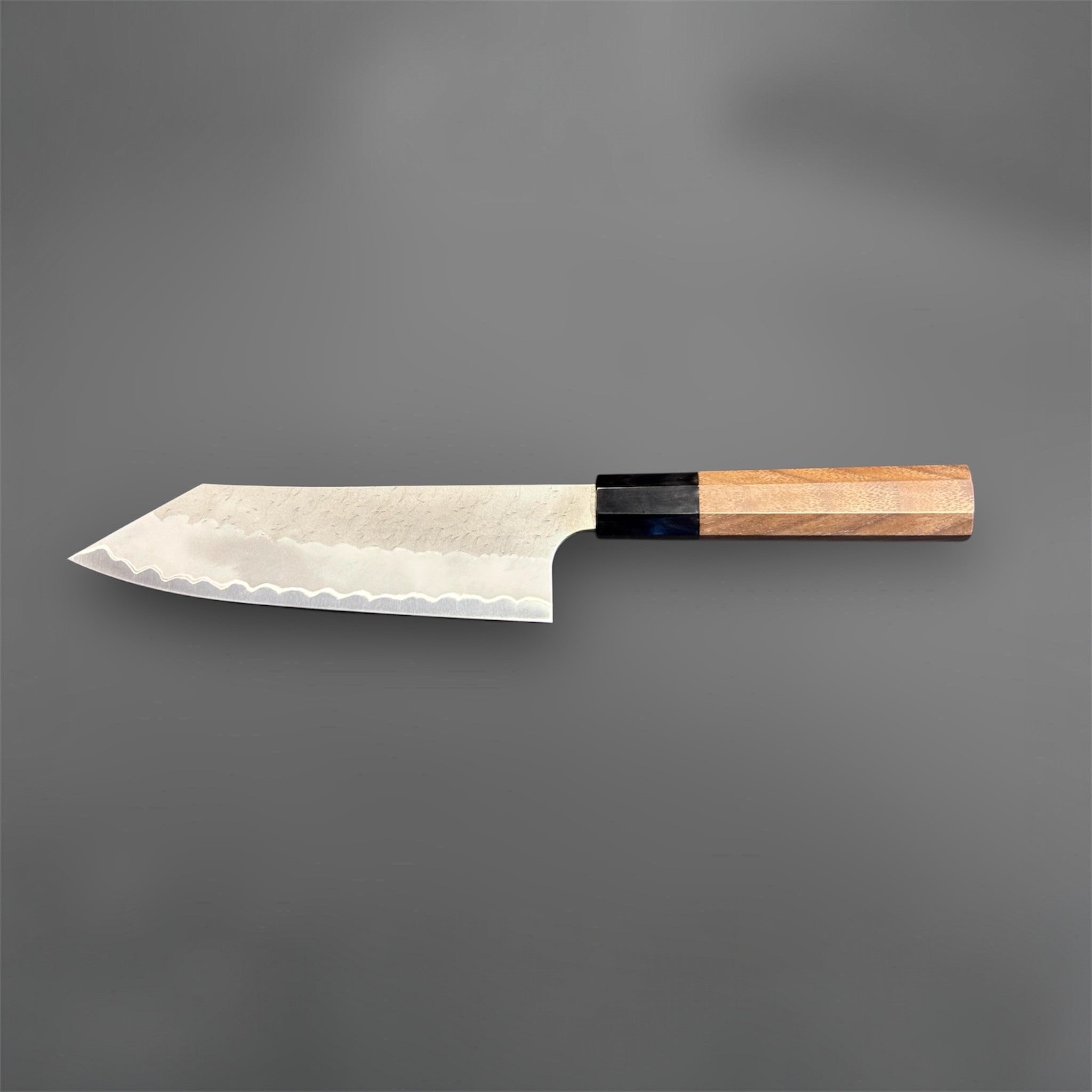 Nigara Aogami Super Steel Tsuchime Bunka 180 mm with walnut and horn handle, full profile view with blade facing left.