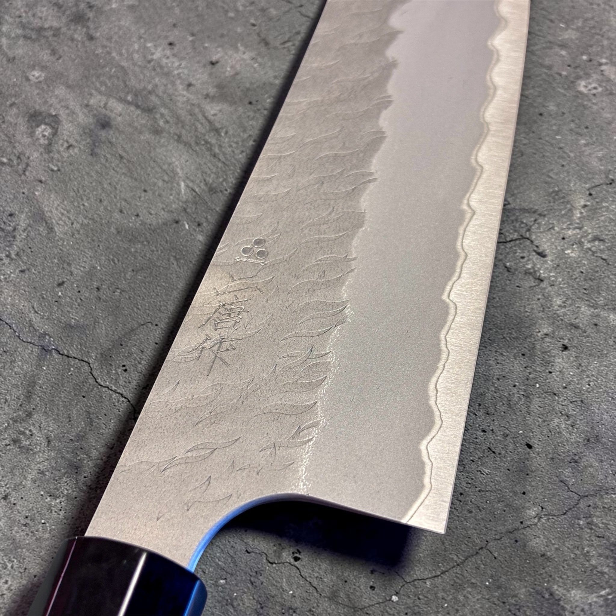 Nigara Aogami Super Steel Tsuchime Bunka 180 mm with walnut and horn handle, close-up of tsuchime texture and engraved blade details.