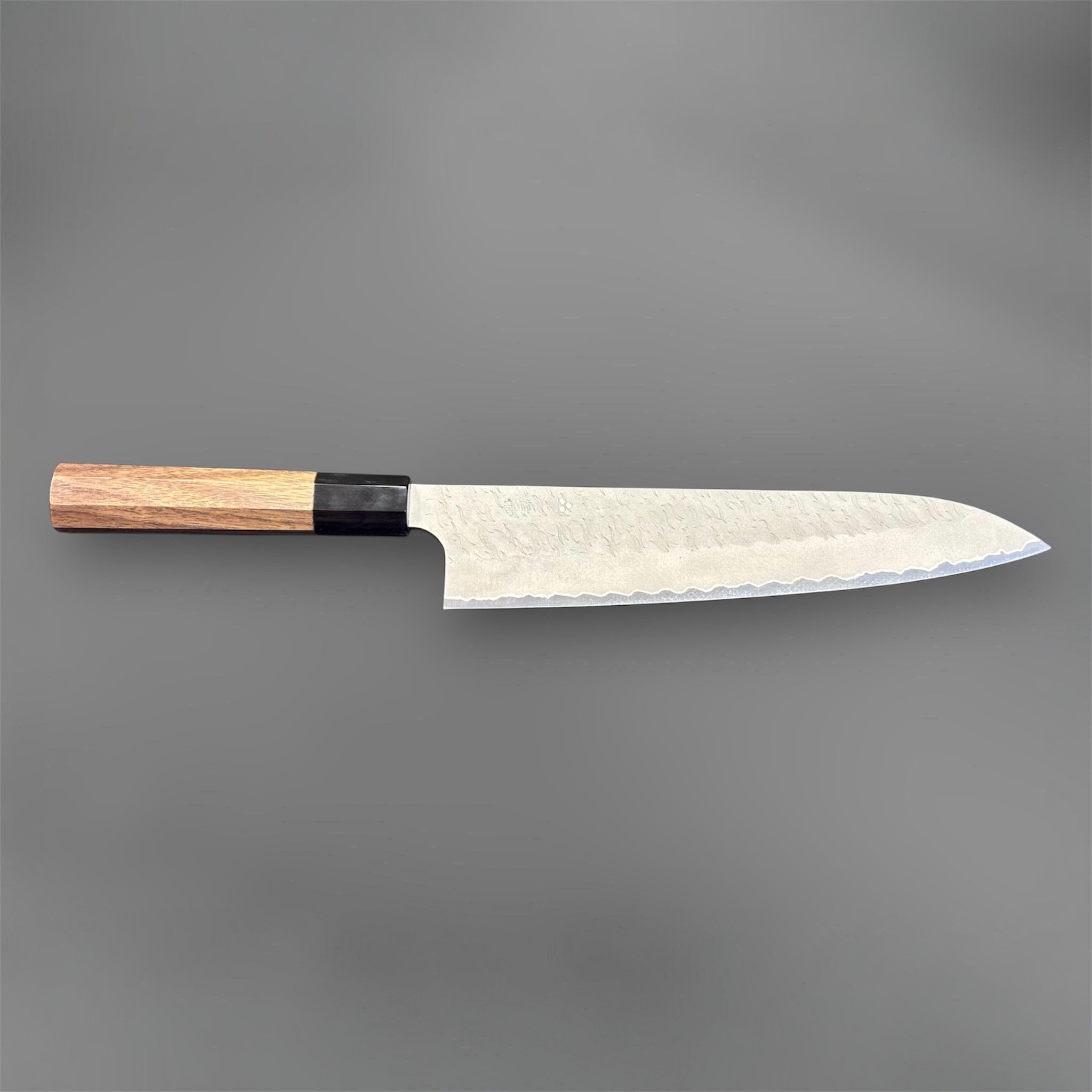 Nigara Aogami Super Steel Tsuchime Gyuto 240 mm with walnut and black horn handle, full profile view with blade facing right.