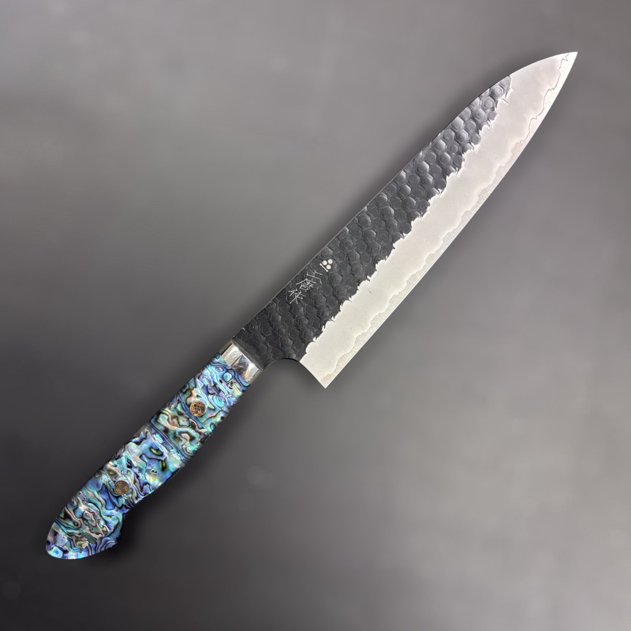 Nigara SG2 Kurouchi Tsuchime Gyuto 210 mm, right side profile showing hammered finish and abalone Western handle.