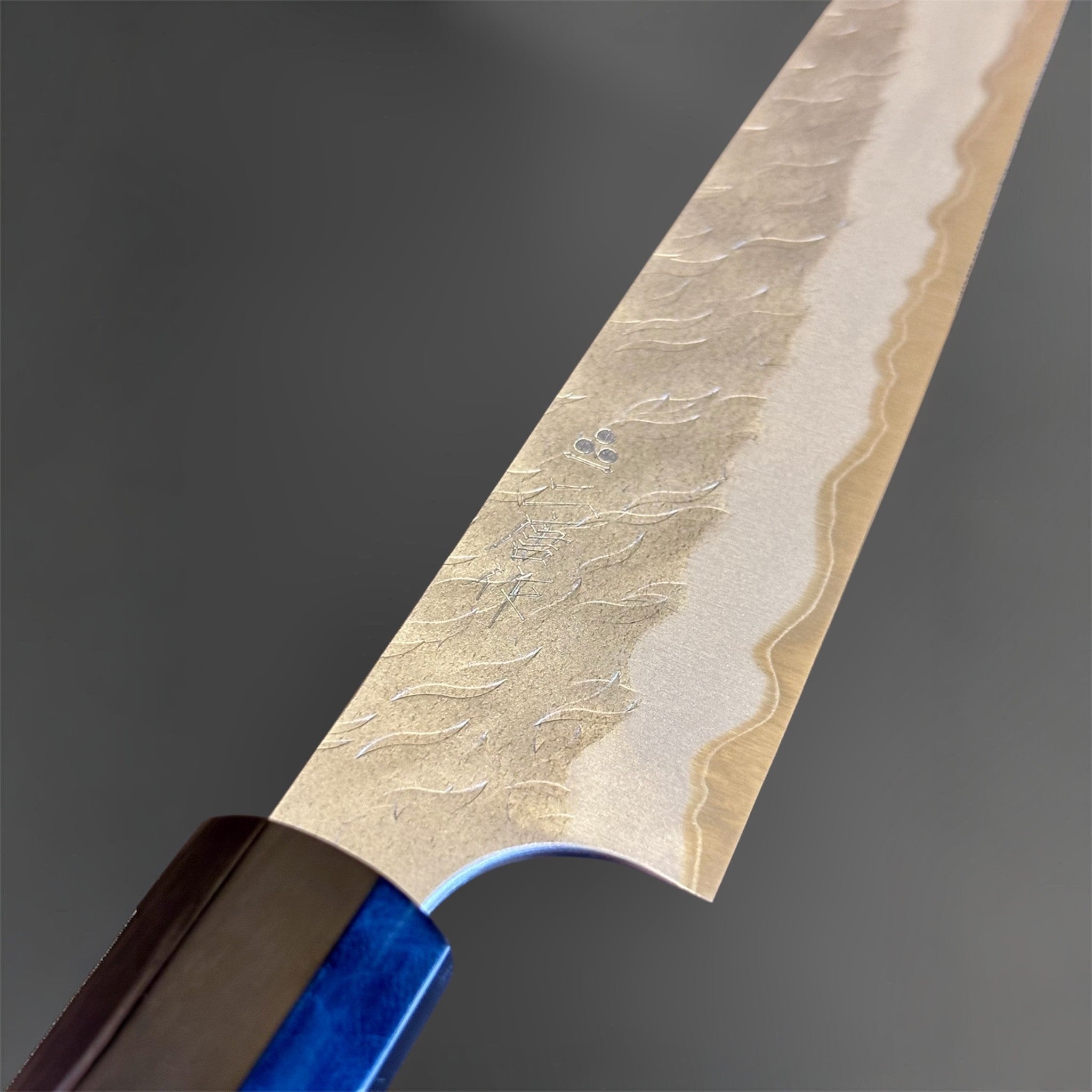 Nigara Hamono Aogami Super Tsuchime Petty 150 mm with walnut horn handle, close-up of blade finish and maker's mark.