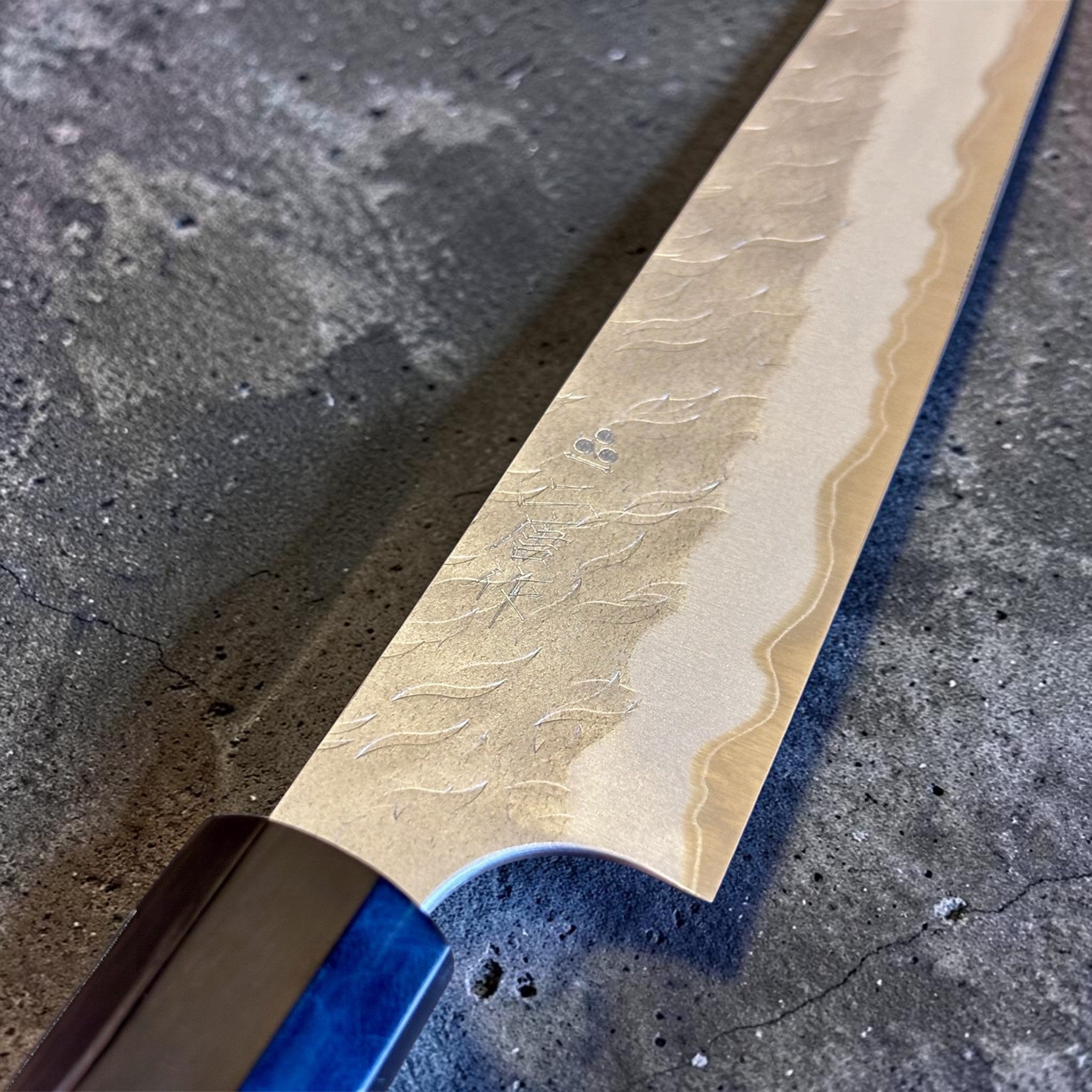 Nigara Hamono Aogami Super Tsuchime Petty 150 mm with walnut horn handle, close-up of blade finish and maker's mark.