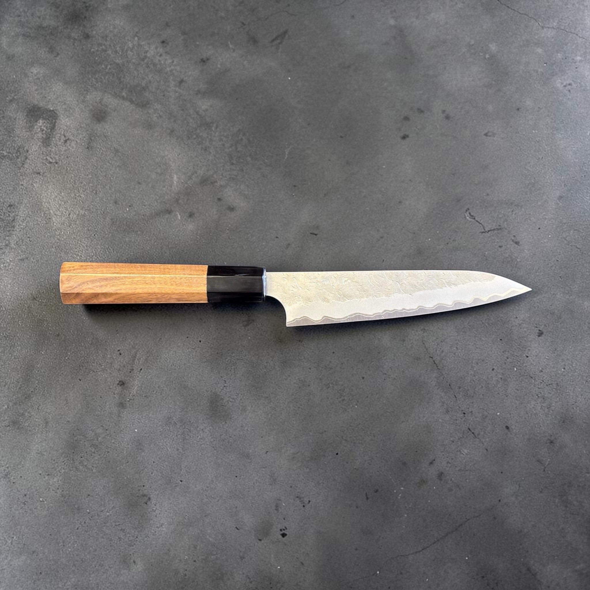 Nigara Hamono Aogami Super Tsuchime Petty 150 mm with walnut horn handle, side profile full knife view.