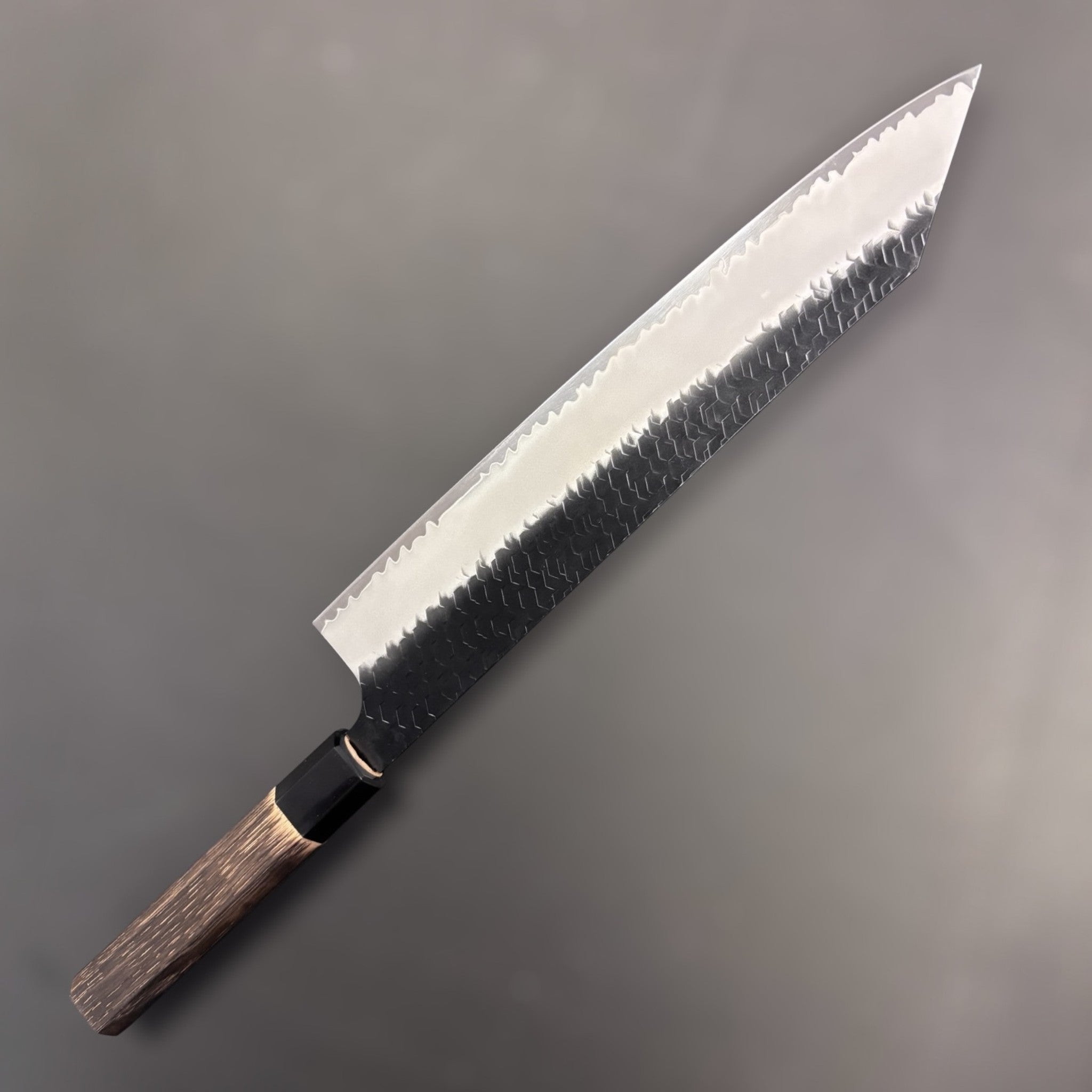 Nigara Hamono SG2 Kurouchi Tsuchime Kiritsuke 270 mm, front side showing kiritsuke tip, hammered cladding, and polished core line.