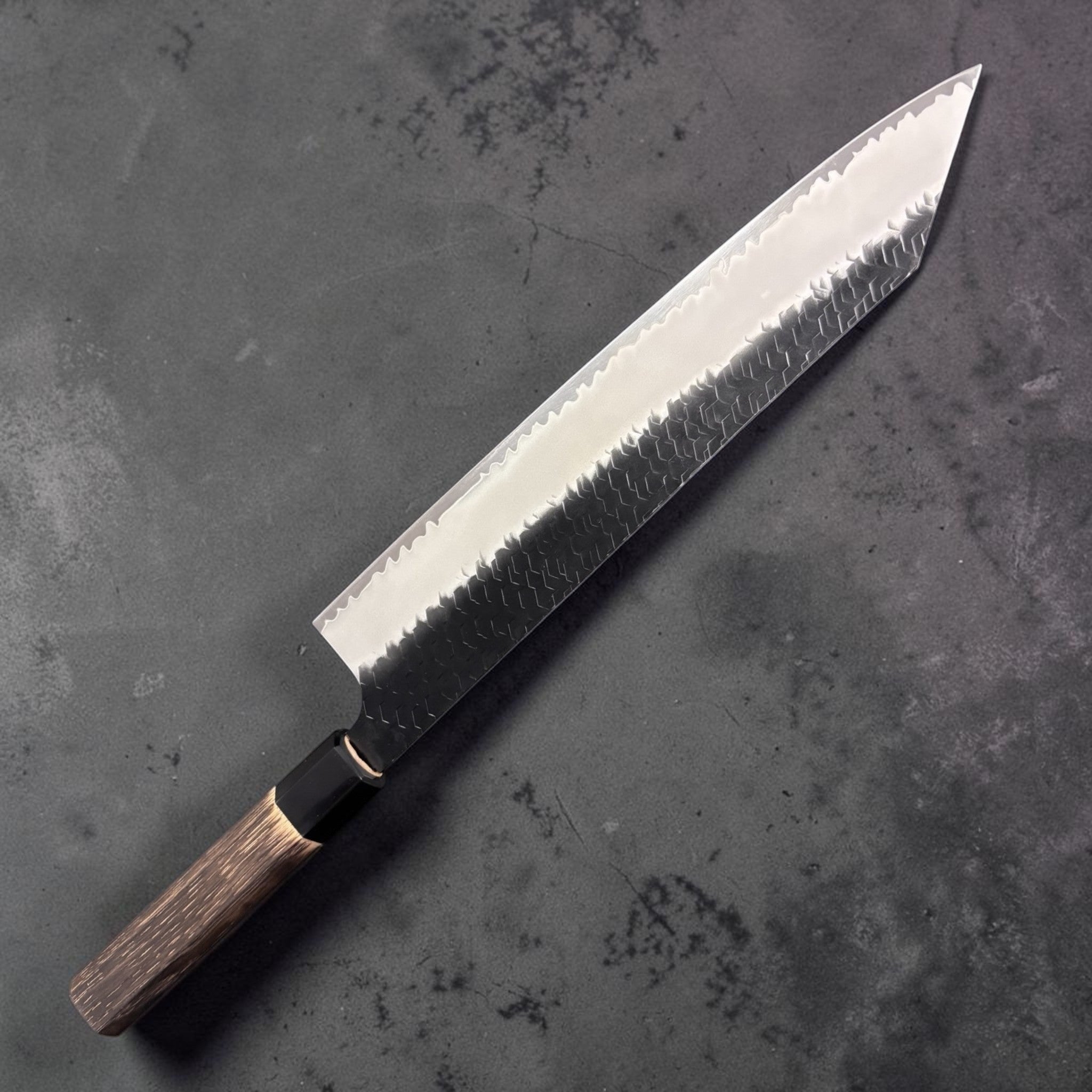 Nigara Hamono SG2 Kurouchi Tsuchime Kiritsuke 270 mm, front side showing kiritsuke tip, hammered cladding, and polished core line.