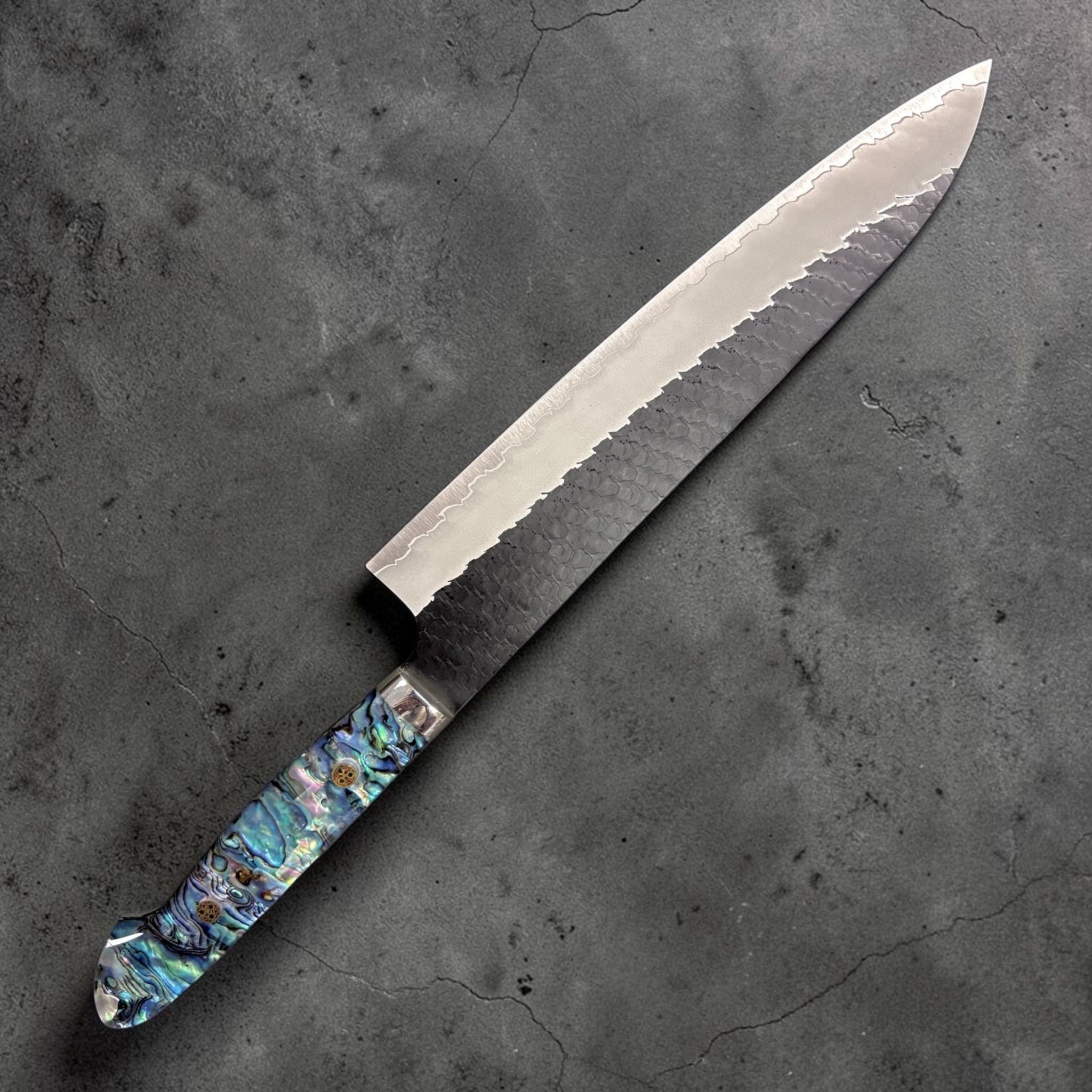Nigara Hamono SG2 Kurouchi Tsuchime Gyuto 240 mm with abalone Western handle, left-side view.